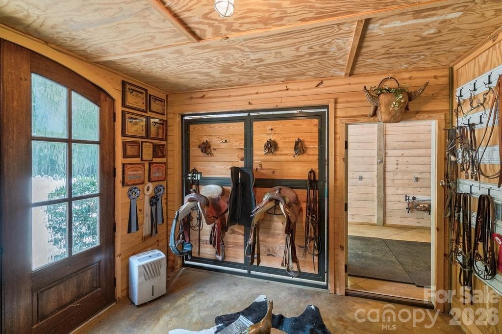 Tack room with tongue &  grove walls, glass and mahogany french doors - 8528 Waxhaw Creek Road, Waxhaw