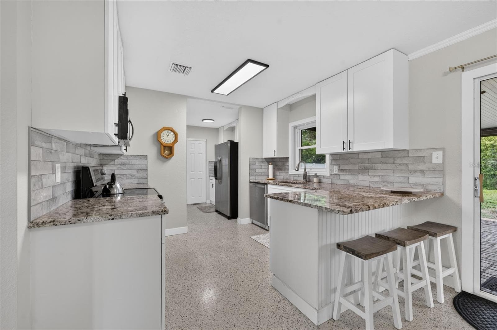 Renovated Kitchen with white shaker cabinets, granite counters and subway tile backsplash - 619 MARSHALL ST, ALTAMONTE SPRINGS