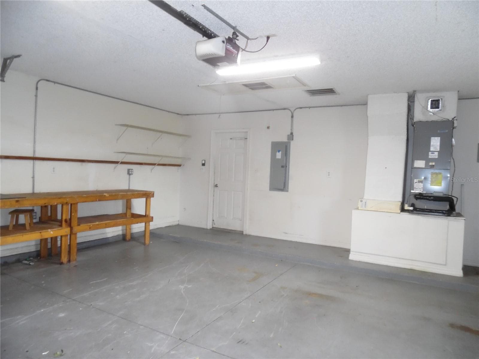 Work bench in two car garage. - 24947 CRANES ROOST CIR, LEESBURG