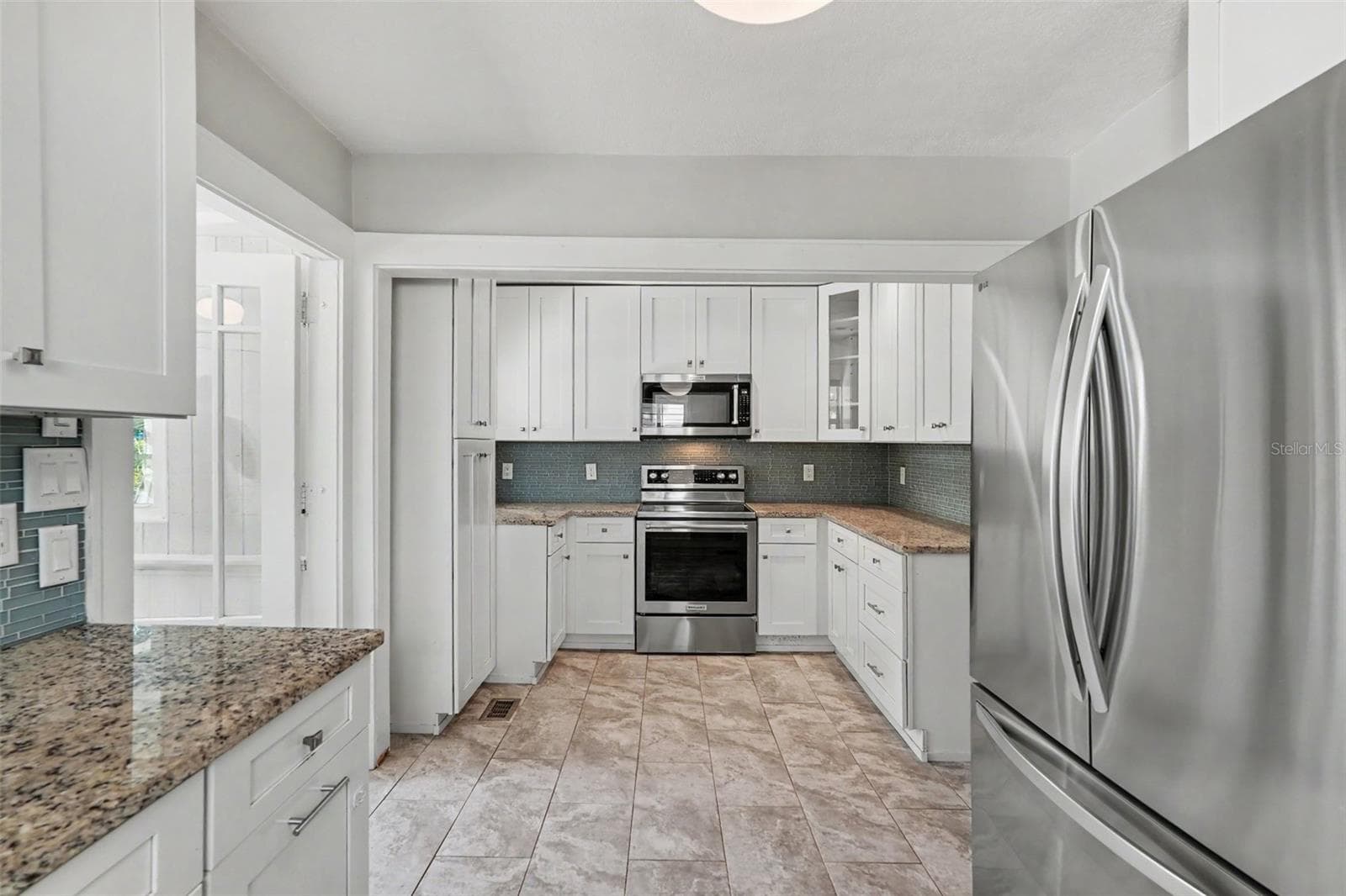The expanded kitchen offers ample cabinetry, generous prep space, and the functionality needed for everyday living and entertaining. - 857 21ST AVE N, ST PETERSBURG