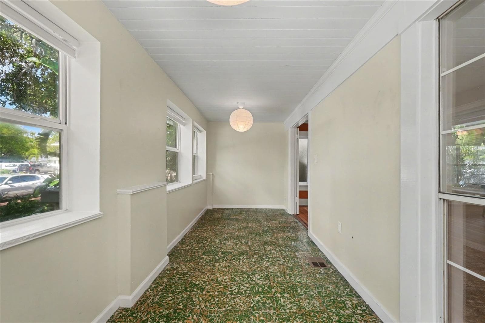 Imagine slow mornings with coffee in this light-filled porch, surrounded by windows and views of the tree-lined neighborhood. - 857 21ST AVE N, ST PETERSBURG