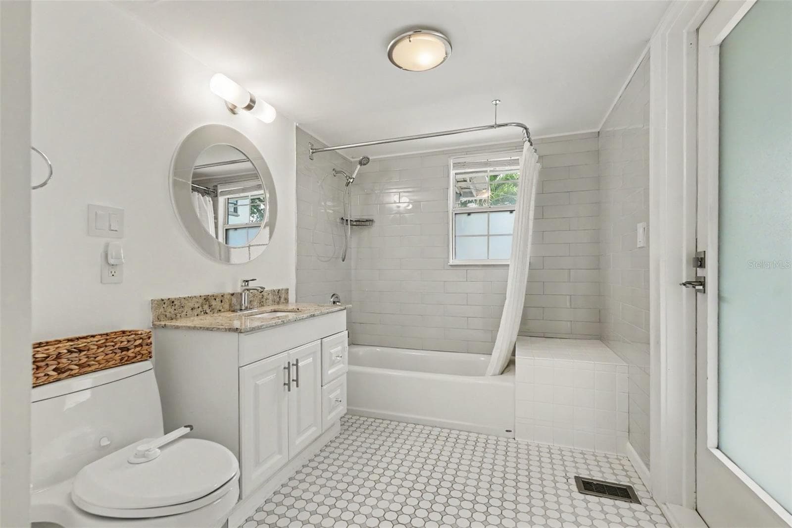 The updated downstairs bath pairs crisp finishes with a layout designed for comfortable everyday living. - 857 21ST AVE N, ST PETERSBURG