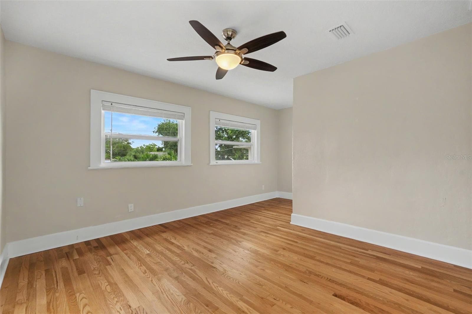 The bedroom offers hardwood floors, abundant natural light, and plenty of room to create a comfortable retreat. - 857 21ST AVE N, ST PETERSBURG