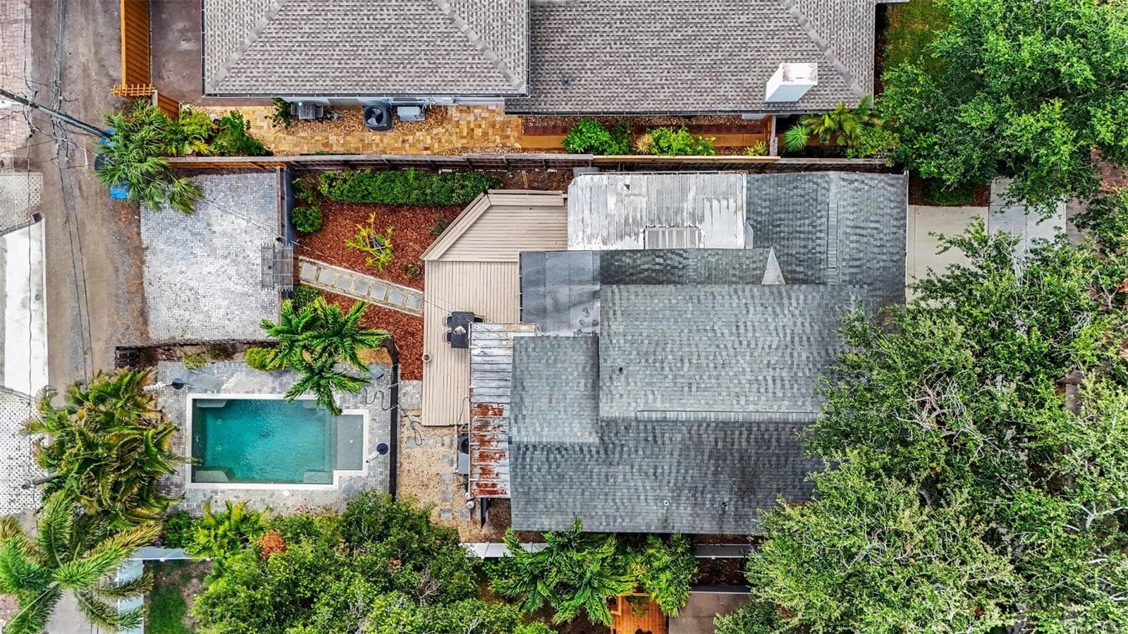 An overhead view shows the home’s layout, pool, deck, mature landscaping, and rear parking area. - 857 21ST AVE N, ST PETERSBURG