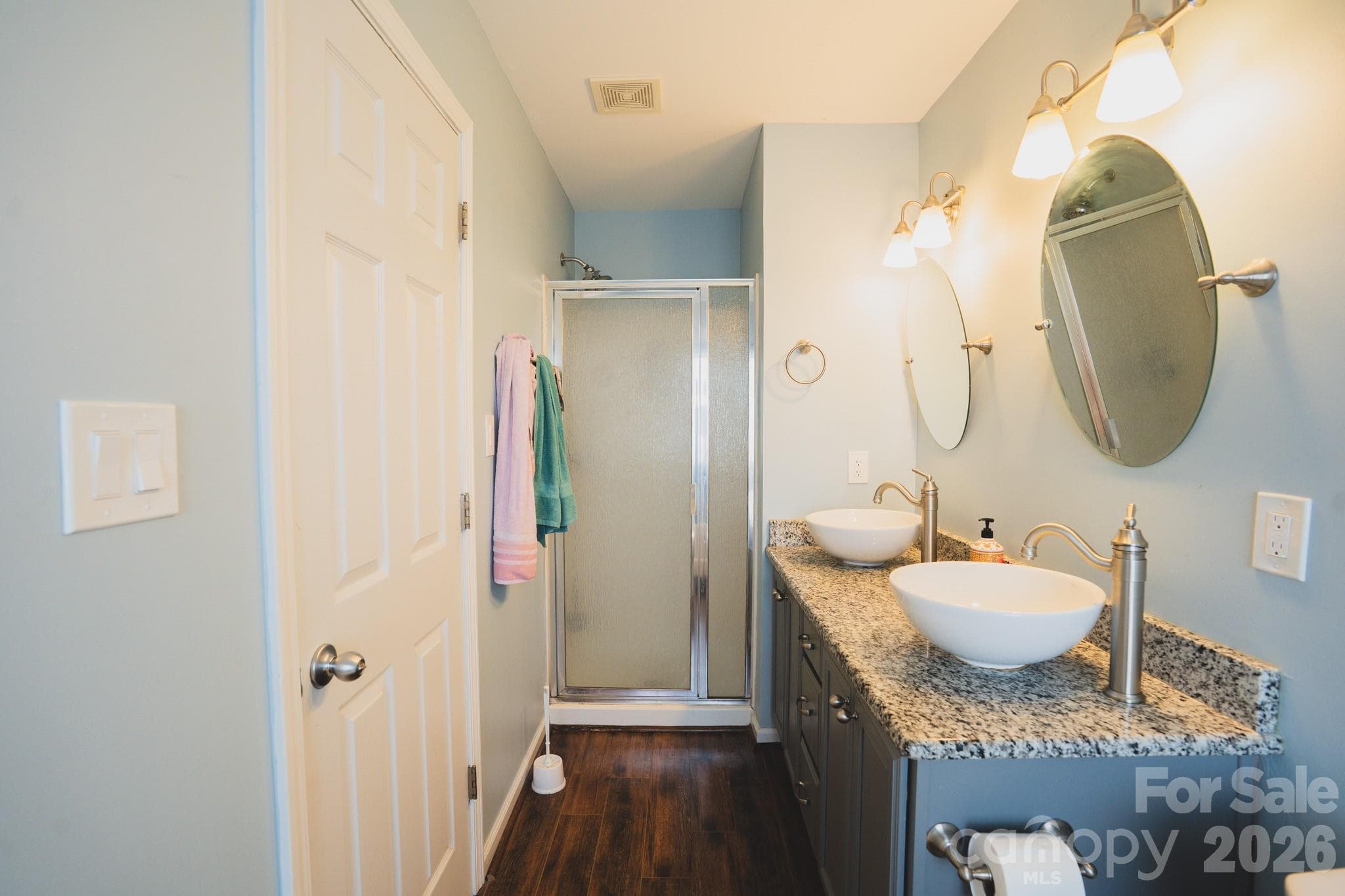 In the primary bedroom is a  separate shower and duel sinks with granite countertops - Charlotte