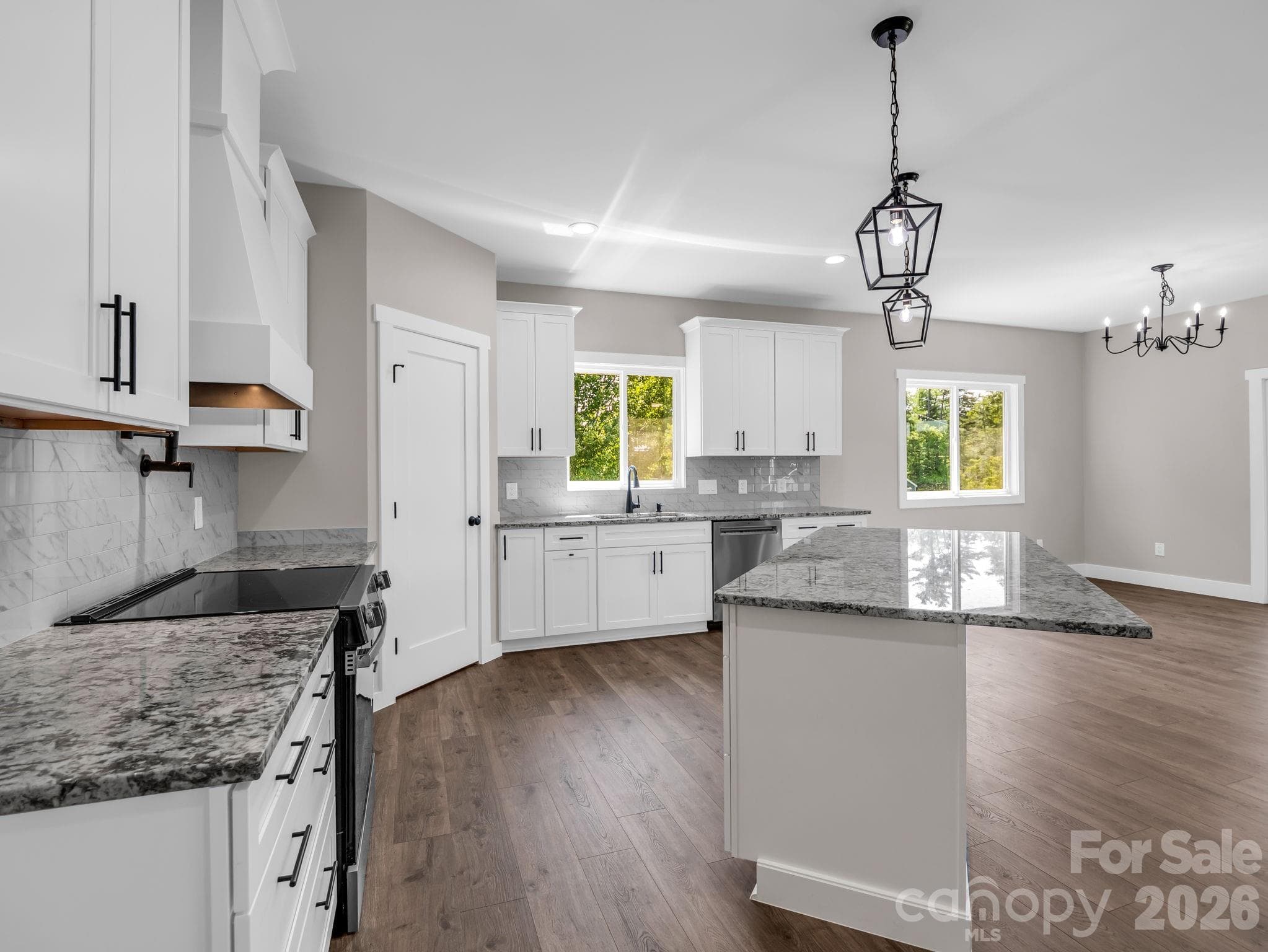 Chef's kitchen with granite counters and stainless appliances (convection electric oven, microwave drawer and dishwasher), stainless appliances, soft close cabinets and large walk-in pantry. - Hendersonville
