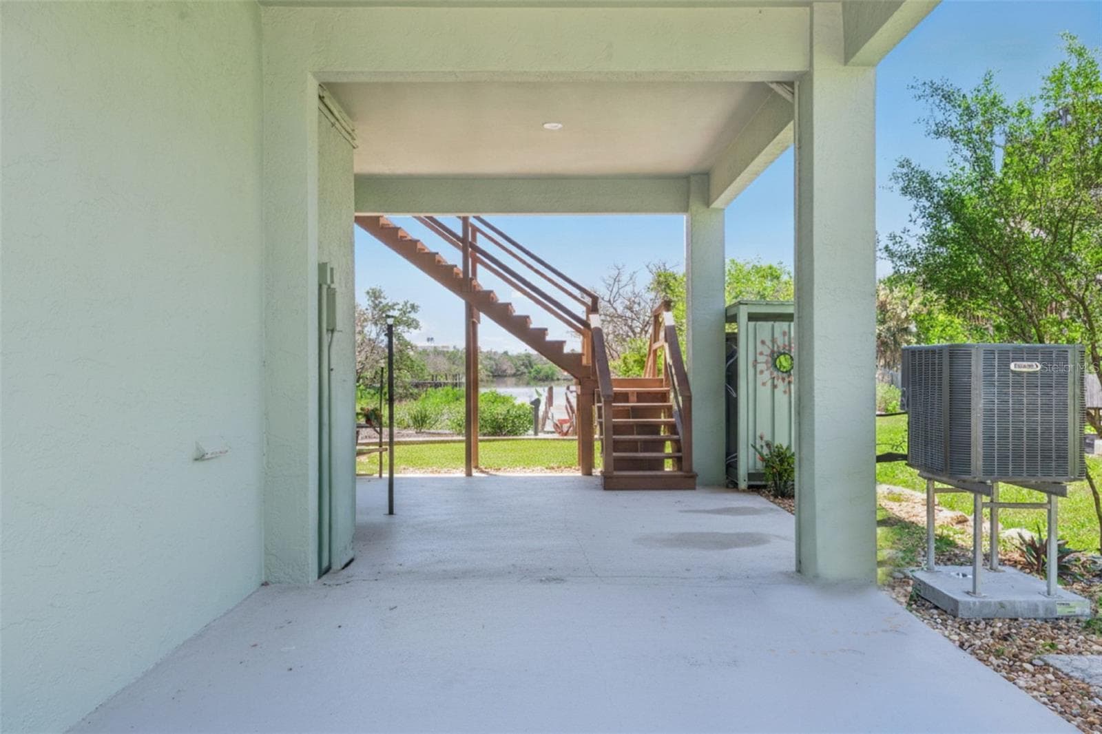Covered carport on west side near stairs and shower. - 884 CATFISH AVE, NEW SMYRNA BEACH
