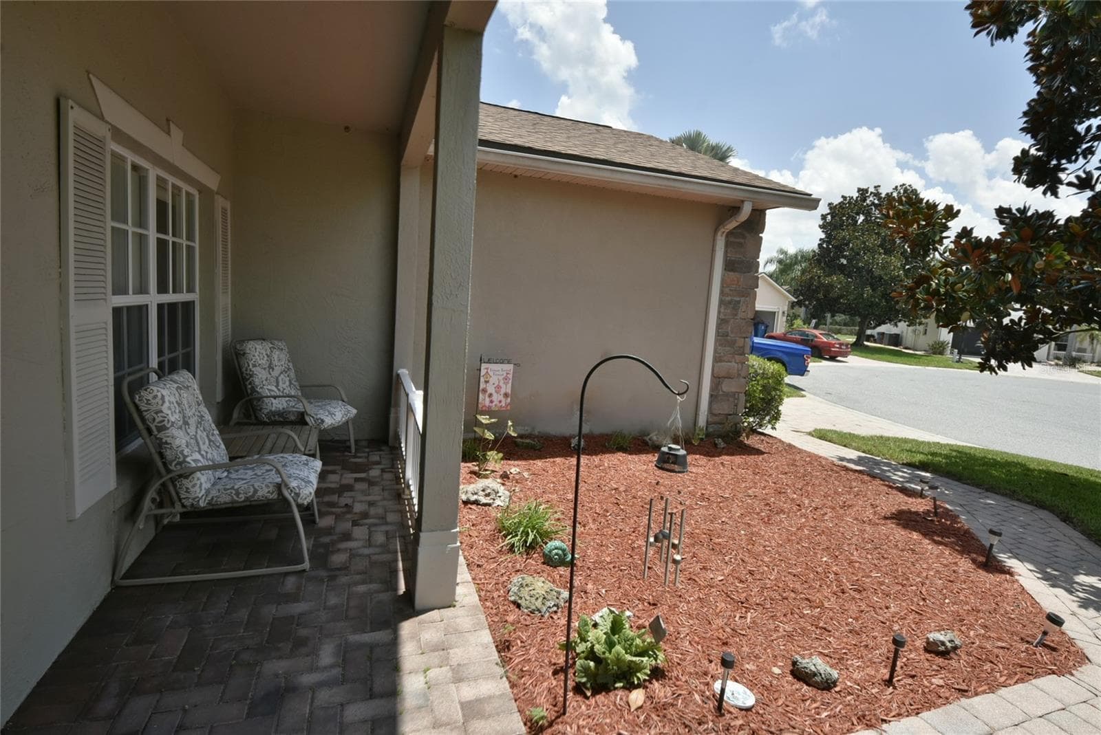 The paver walkway leads to the covered front entry. - 4360 ASHTON CLUB DR, LAKE WALES