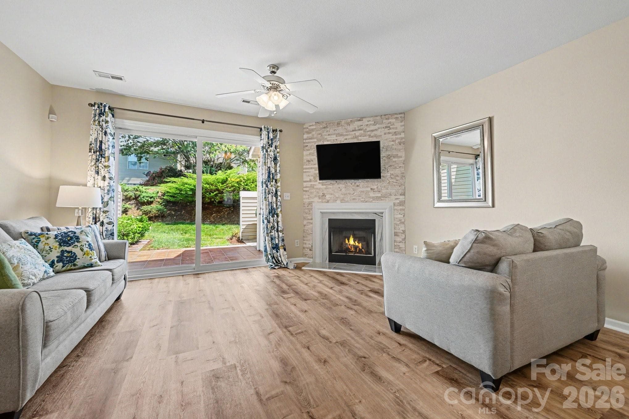 Open floor plan: accent wall of stone tile pieces encase fireplace! - 5338 Silabert Avenue, Charlotte