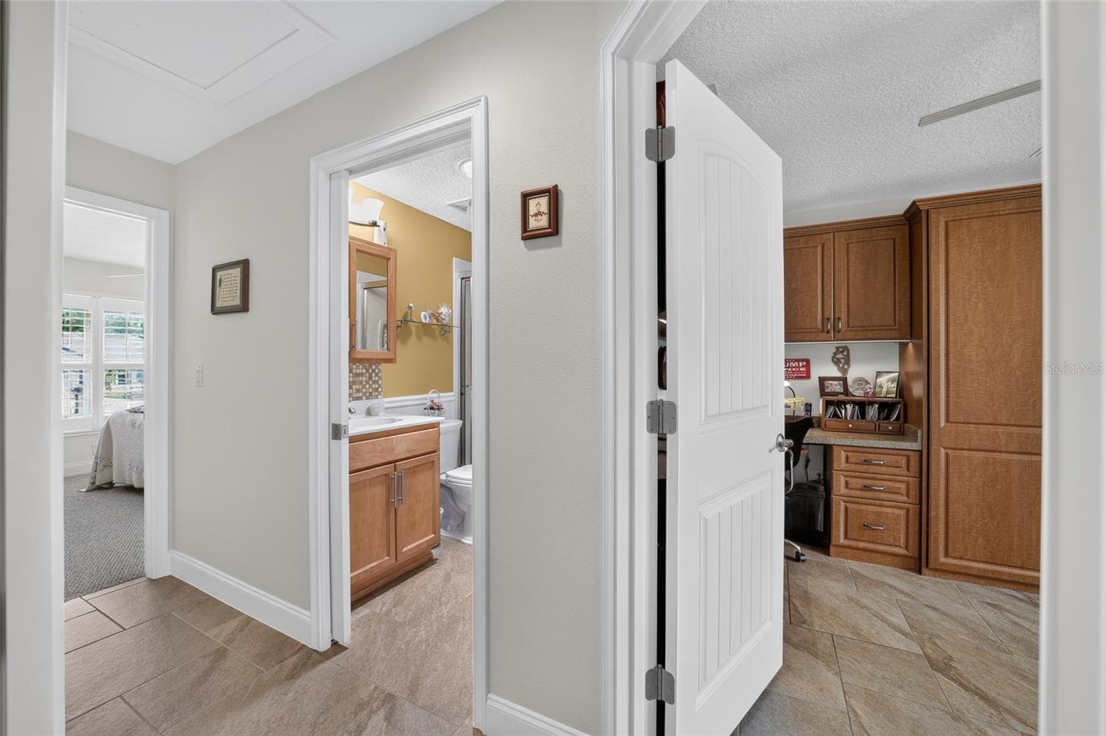 Hallway showing doors to both guest bedrooms and guest bathroom - 16364 SE 89TH TER, SUMMERFIELD
