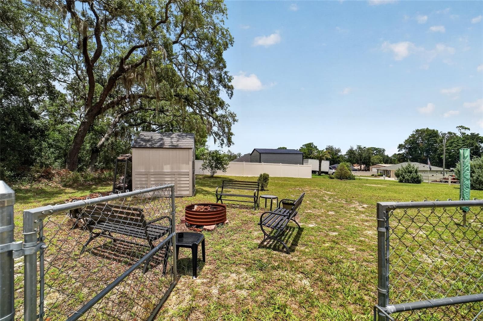 Gate to extra lot with fire pit and additional shed - 16364 SE 89TH TER, SUMMERFIELD