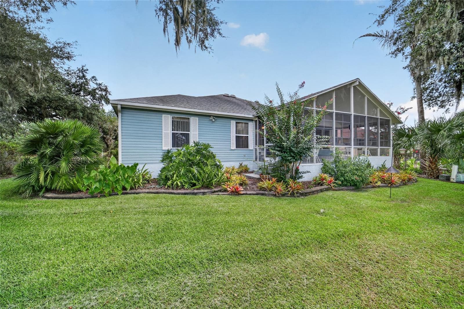 Back of House with Lanai from Golf Course - 1230 DESILVA ST, THE VILLAGES