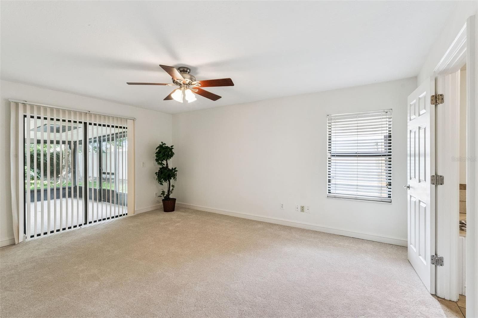 Primary Bedroom with Sliding Glass Doors - 9433 PALM TREE DR, WINDERMERE