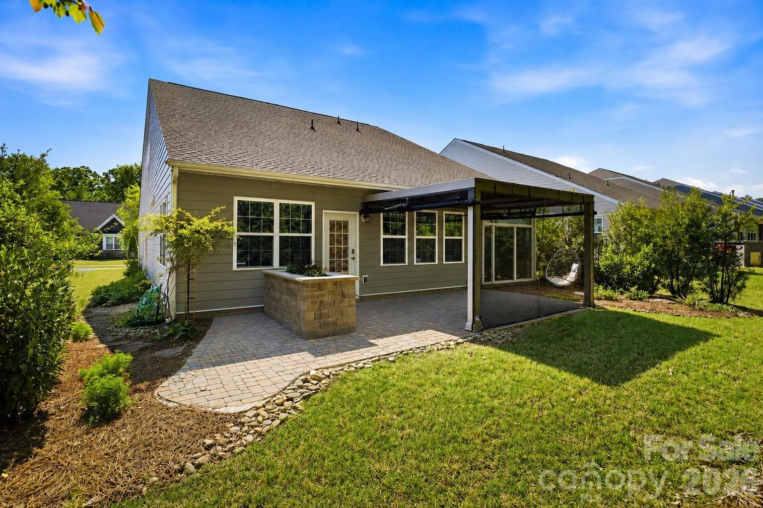 Enjoy year-round outdoor living with an extended paver patio and a StruXure motorized pergola featuring integrated lighting, a ceiling fan, heaters, and a rain sensor. - Mount Holly
