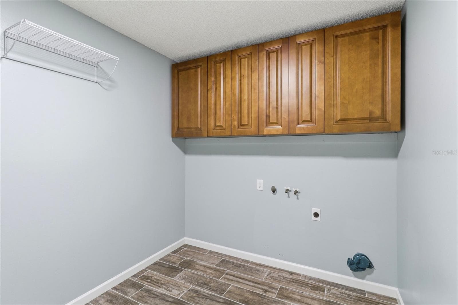 Inside Laundry room with storage and door to garage - 302 BLOOMINGFIELD DR, BRANDON