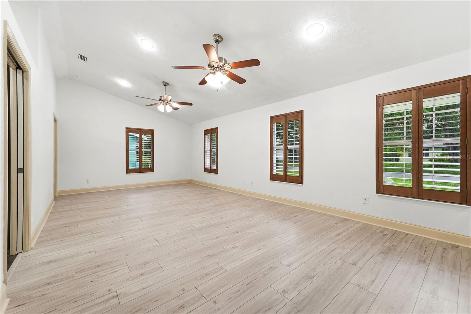Vaulted ceilings and abundant natural light create an open, airy atmosphere. - 59 CRESTWOOD CIR, ORMOND BEACH