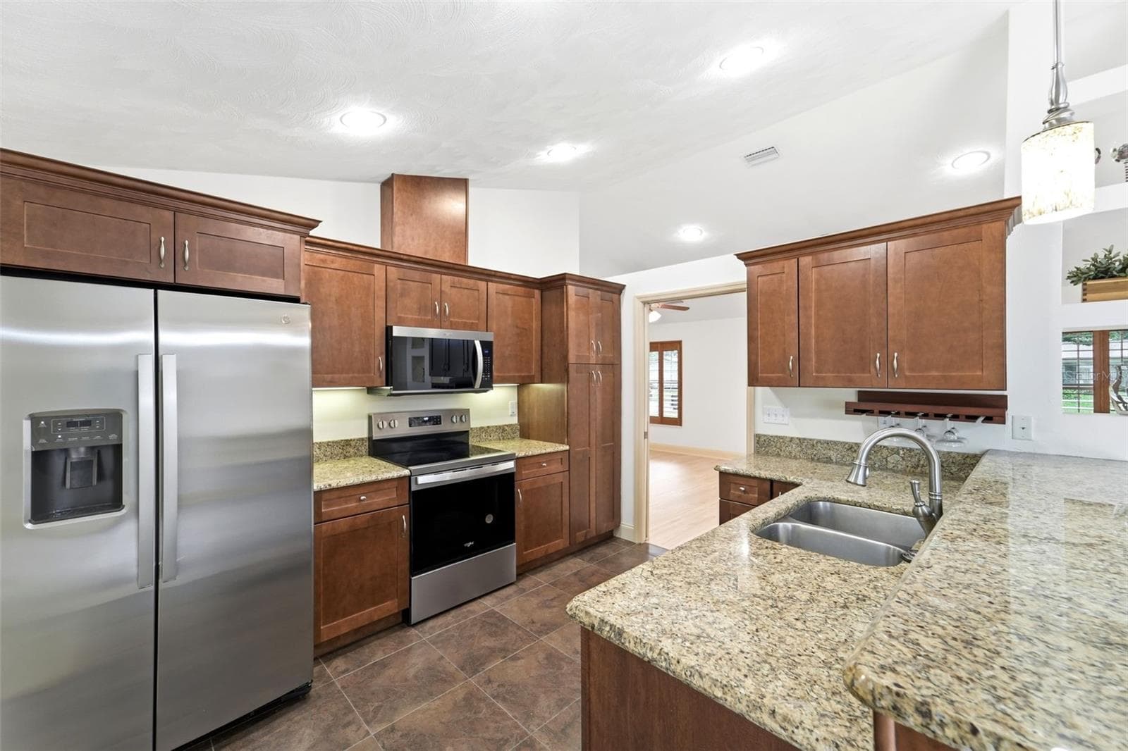 The heart of the home features generous workspace and seamless flow into the living areas. - 59 CRESTWOOD CIR, ORMOND BEACH