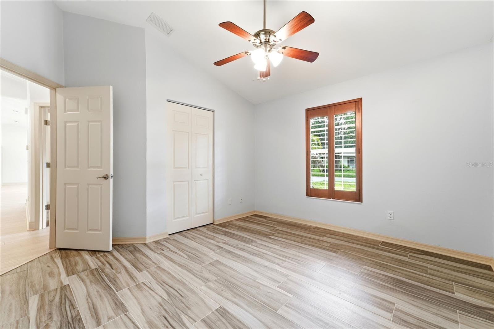 Bedroom two with built in closet and plantation shutters. - 59 CRESTWOOD CIR, ORMOND BEACH