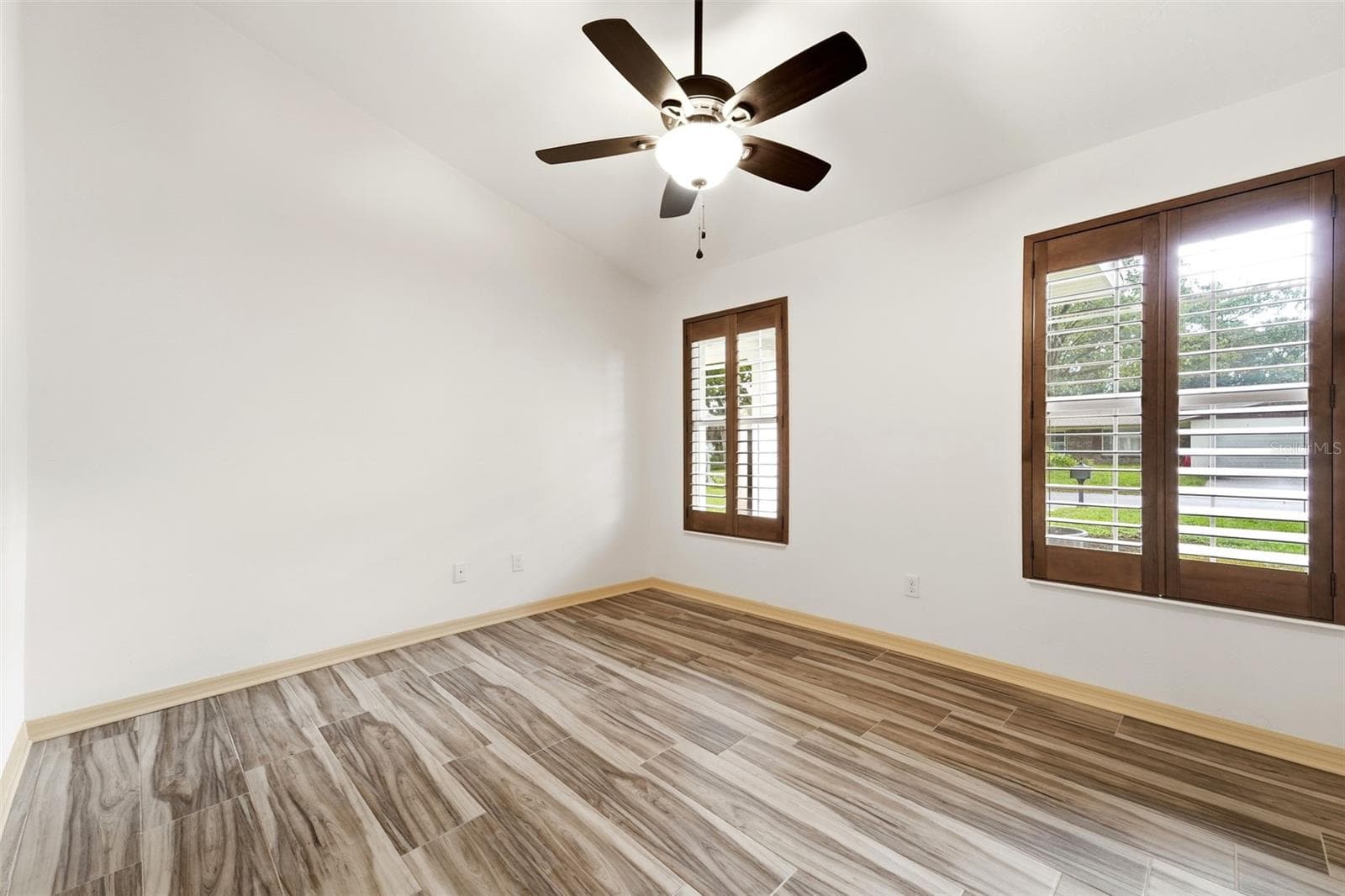 Plantation shutters and vaulted ceilings add warmth and character throughout. - 59 CRESTWOOD CIR, ORMOND BEACH
