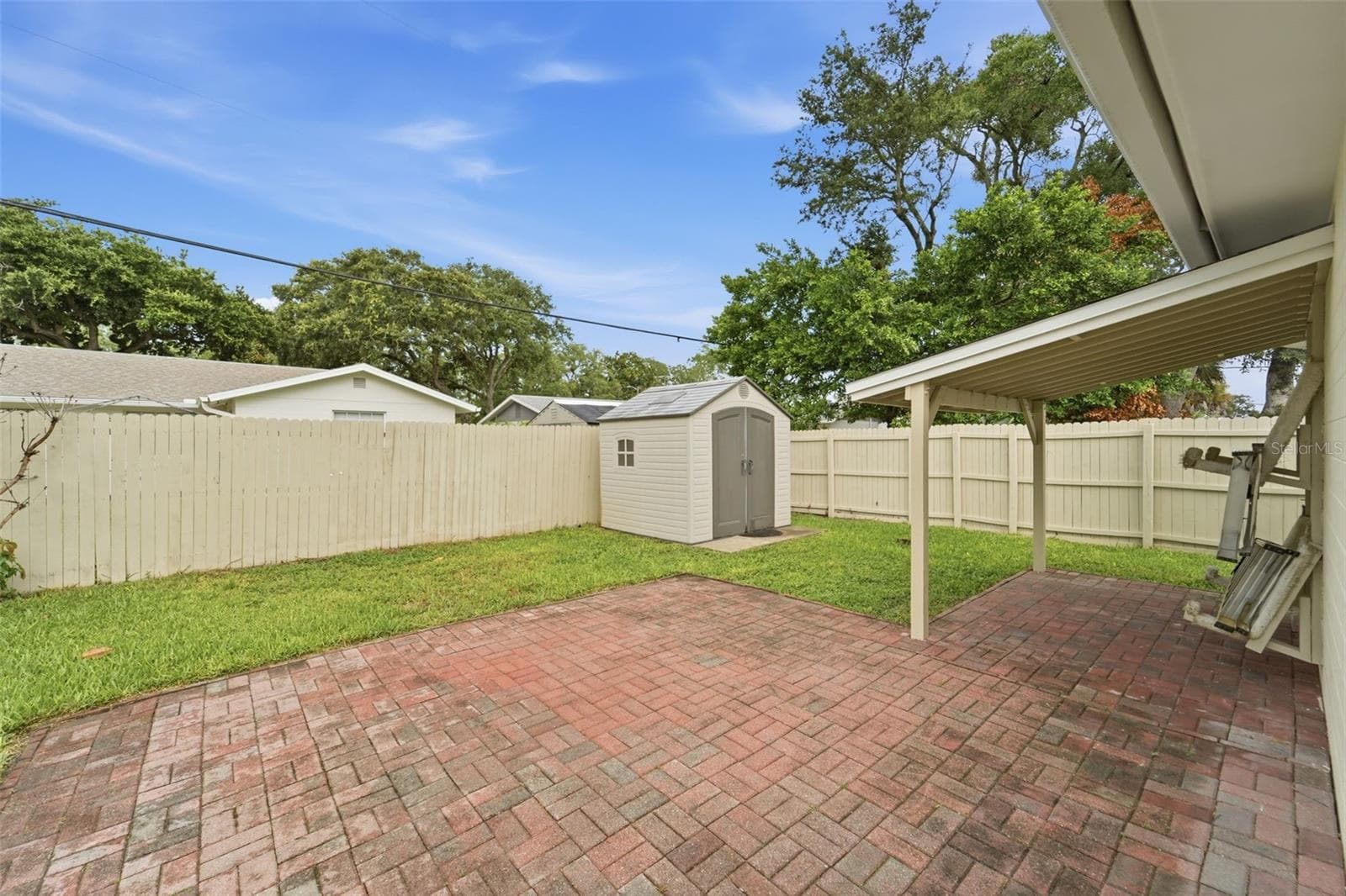 Enjoy your morning coffee or evening gatherings under the covered patio. - 59 CRESTWOOD CIR, ORMOND BEACH