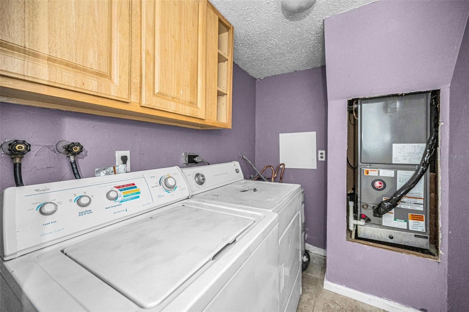 inside laundry room with cabinets and full size washer and dryer - 1960 UNION ST #5, CLEARWATER