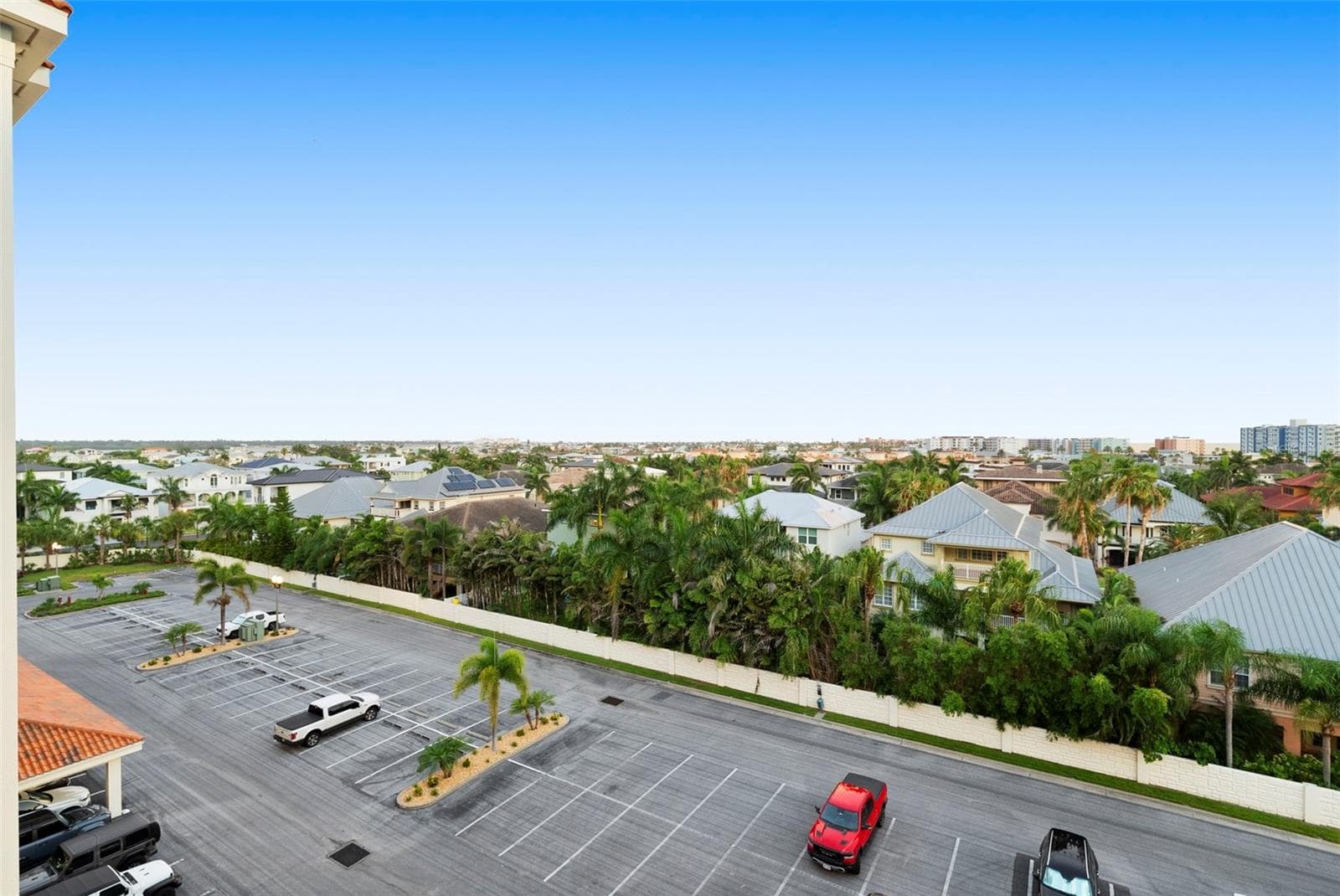 Front view from units door to parking lot of front with PLENTY IF GUEST PARKING , which is rare for beach communities. Enjoy gatherings from friends and family with secured parking lot , carports avail and under building assigned parking - 17717 GULF BLVD #604, REDINGTON SHORES