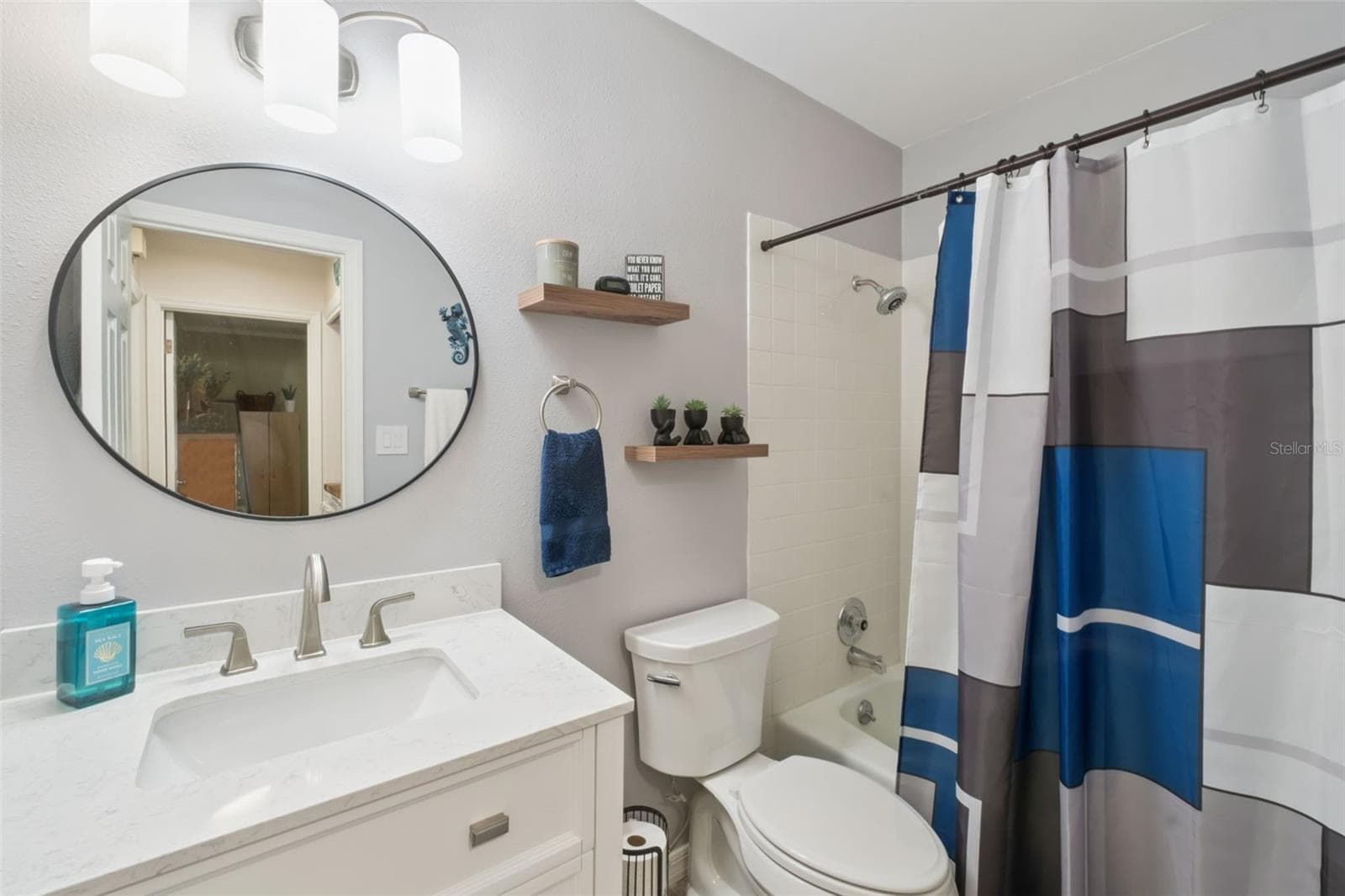 Guest bathroom with new vanity, mirror and flooring. - 1112 VILLA LN #84, APOPKA