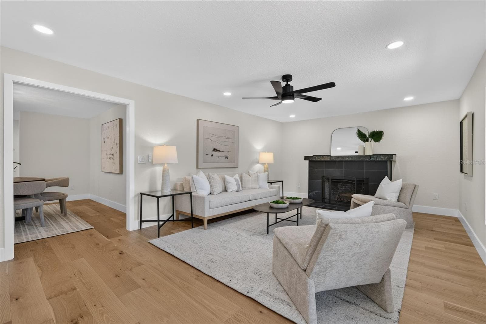View of living room with a peek into the adjacent dining room - 310 PARK ST N, ST PETERSBURG
