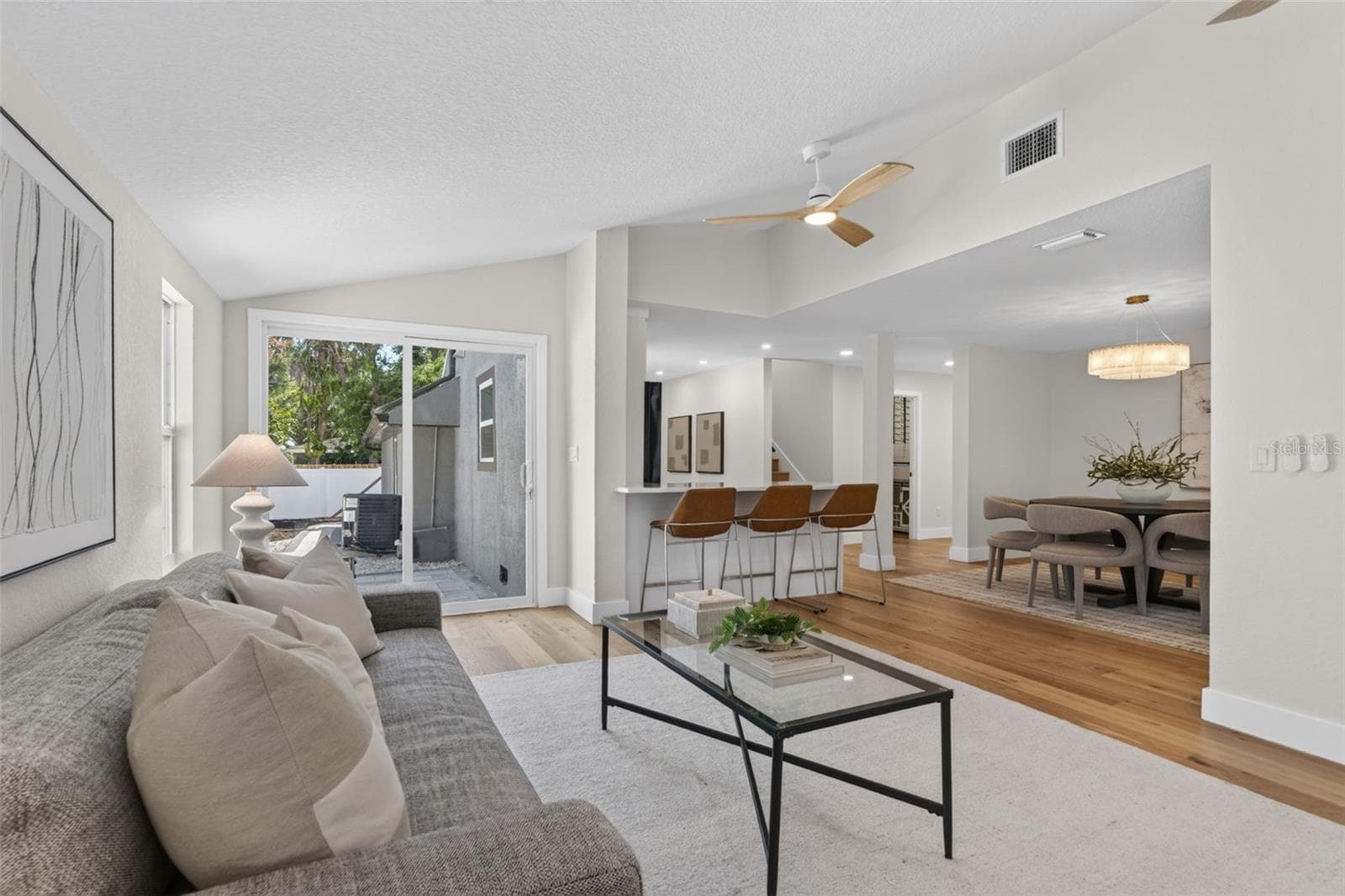 Family room with view of slider to the rear yard and patio area - 310 PARK ST N, ST PETERSBURG