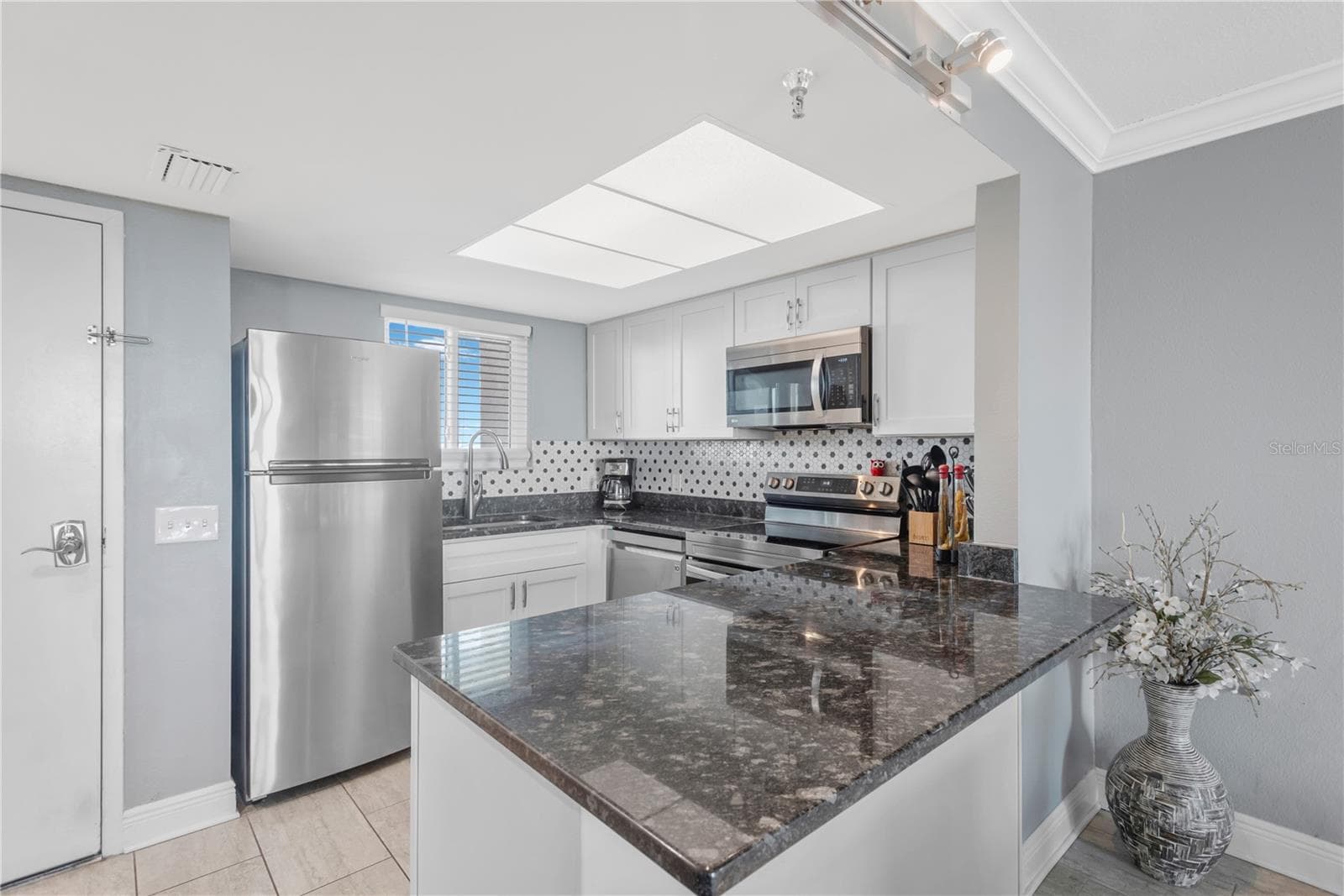Step inside and experience this exquisite kitchen with stainless appliances, breakast island and beautiful appointments. - 5915 SEA RANCH DR #503, HUDSON
