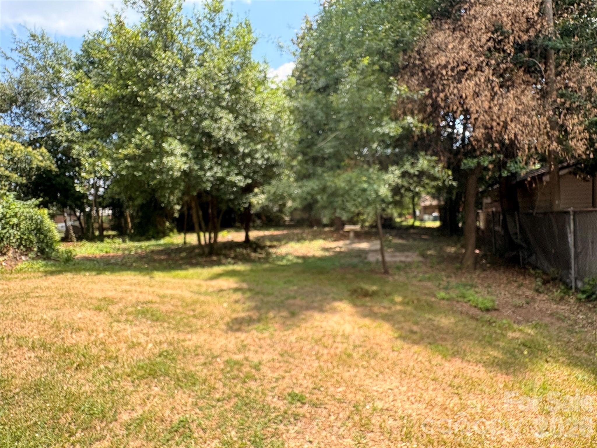 Spacious back yard with mature trees. - 725 5th Avenue SW, Hickory