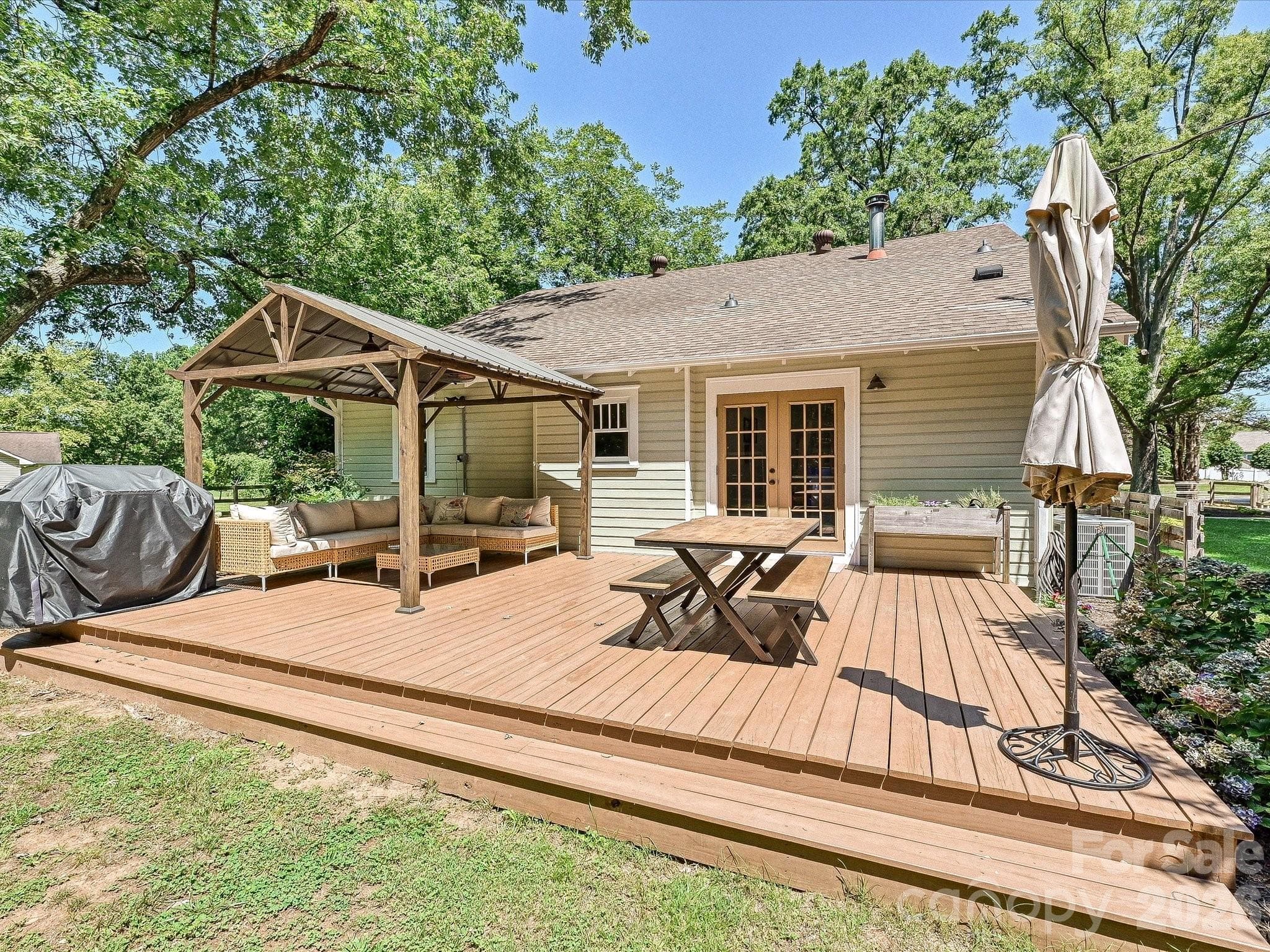 The huge back deck offers plenty of room for outdoor dining, grilling, and entertaining beneath the covered gazebo. - 3514 Kelly Road, Charlotte