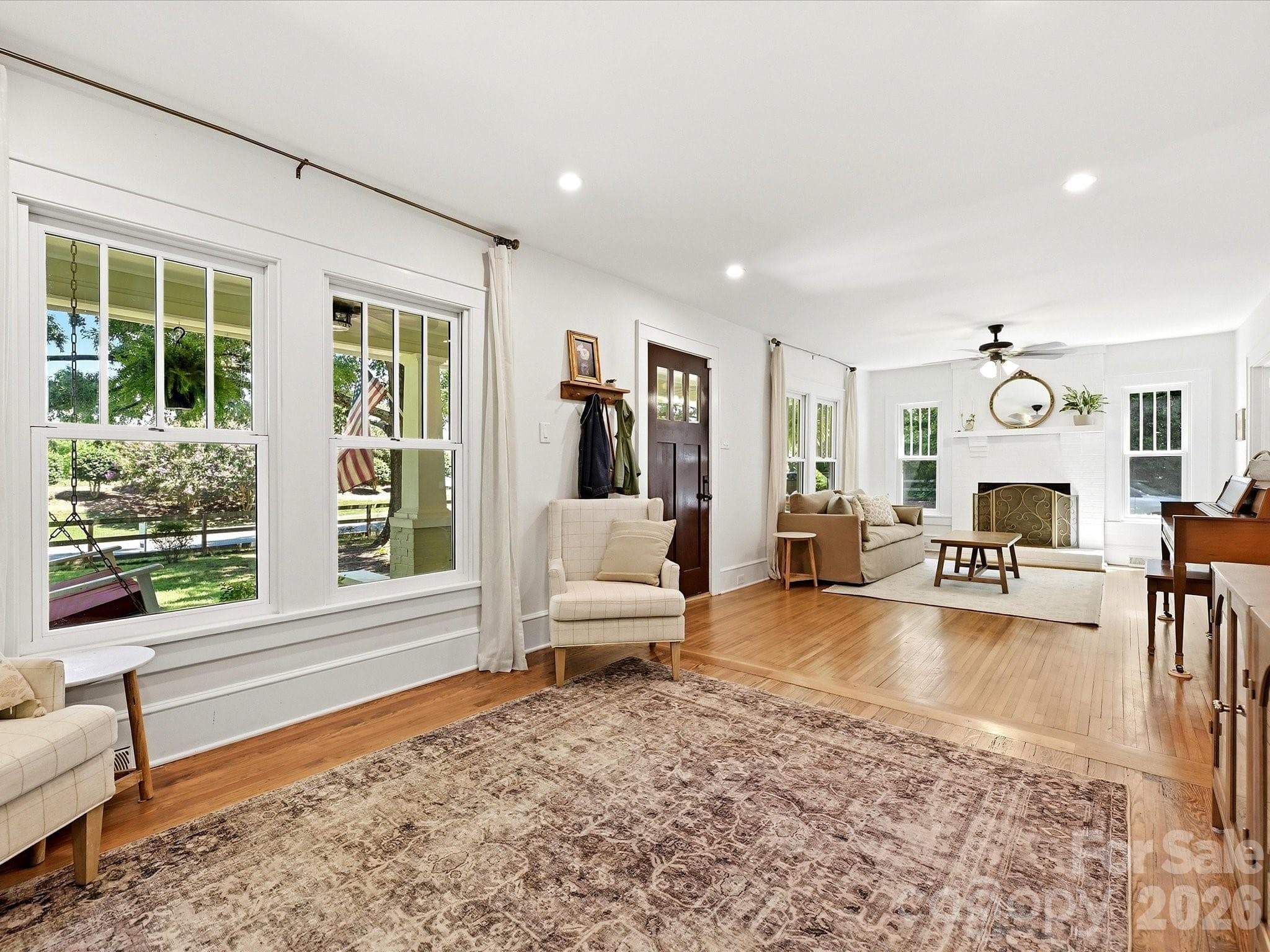 The spacious living room showcases beautiful hardwood floors, abundant natural light, and a seamless flow that is perfect for everyday living and entertaining. - 3514 Kelly Road, Charlotte