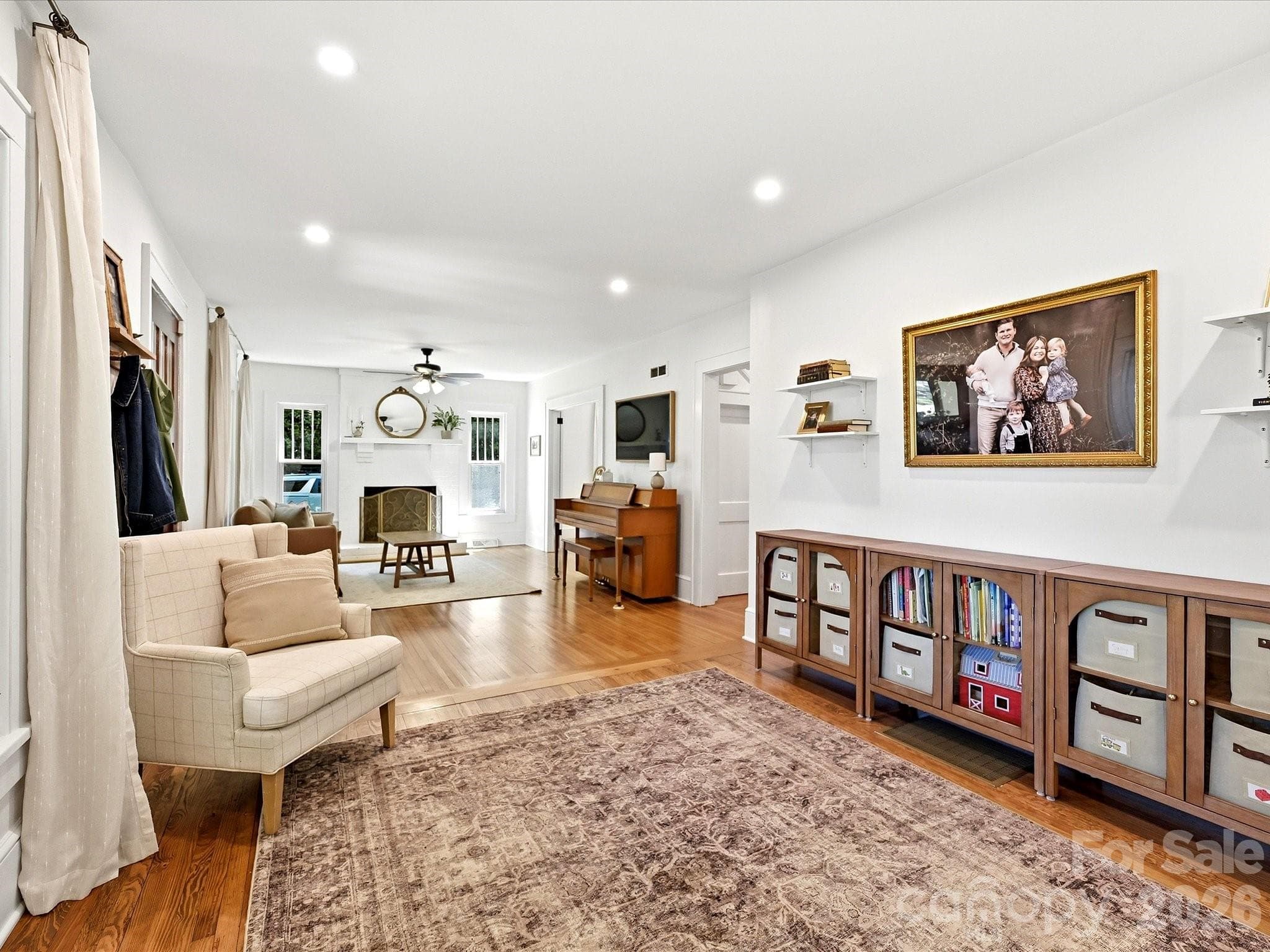 The spacious living room showcases beautiful hardwood floors, abundant natural light, and a seamless flow that is perfect for everyday living and entertaining. - 3514 Kelly Road, Charlotte