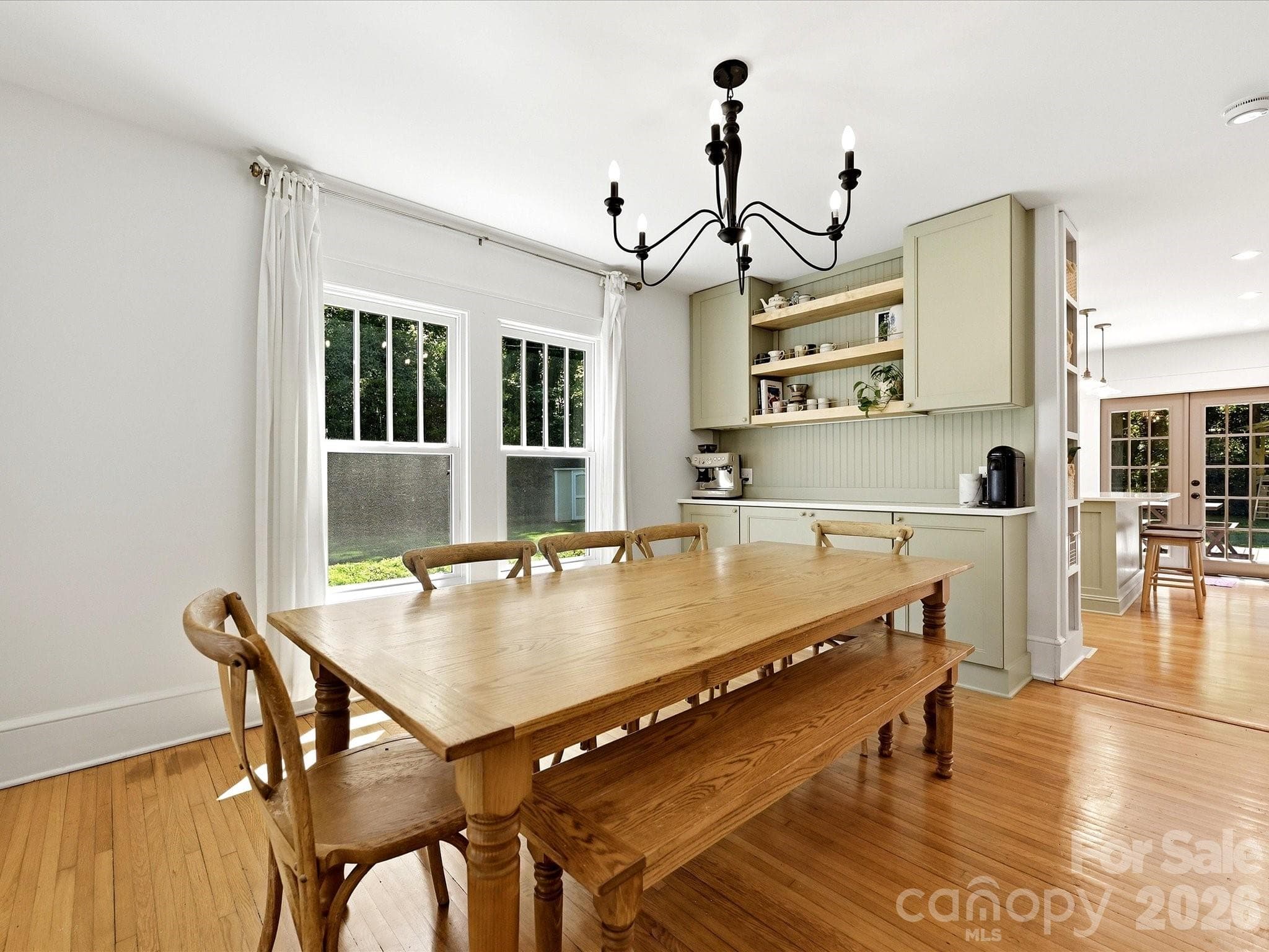 French doors connect the formal dining room to the main living area, creating a flexible layout ideal for both entertaining and everyday living. - 3514 Kelly Road, Charlotte