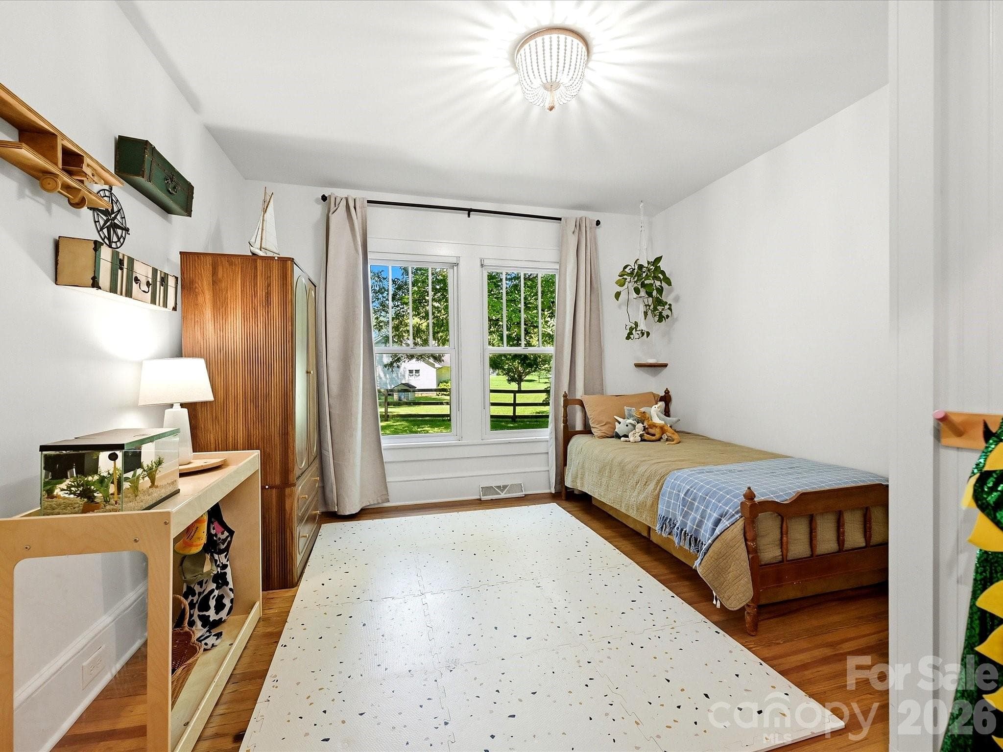 This charming secondary bedroom features hardwood floors, large windows, and flexible space for family, guests, or a home office. - 3514 Kelly Road, Charlotte