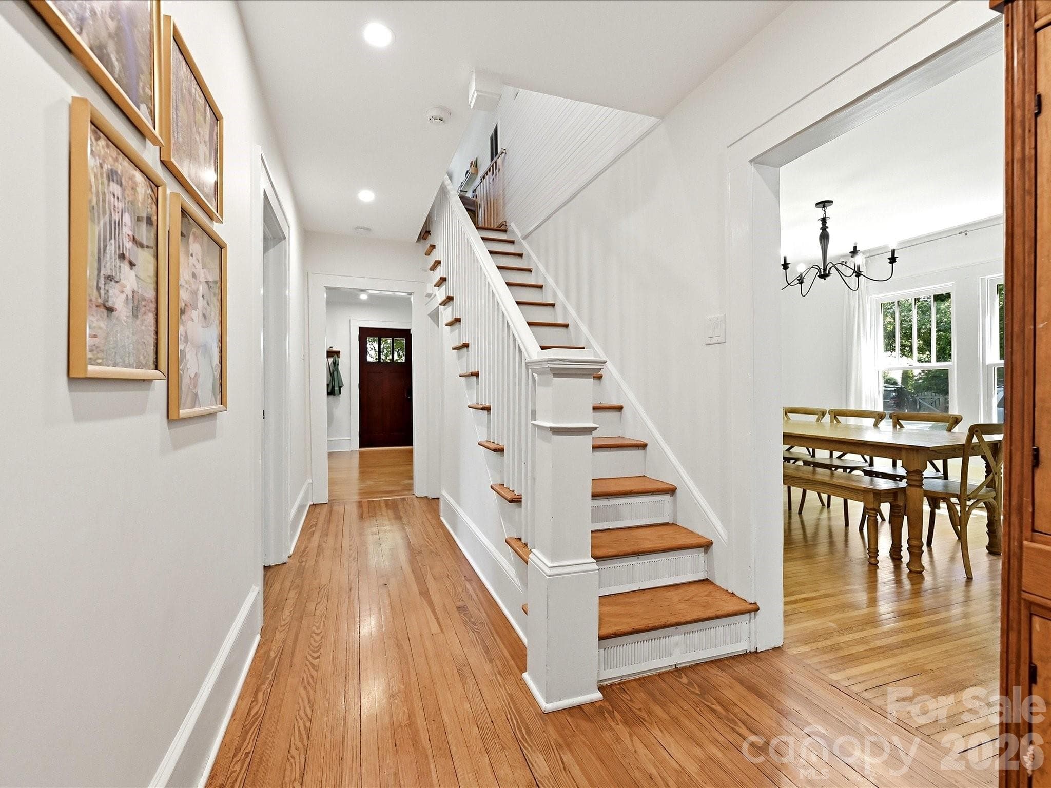 A classic staircase and wide hallway showcase timeless craftsmanship while providing easy access to the home's upper level. - 3514 Kelly Road, Charlotte