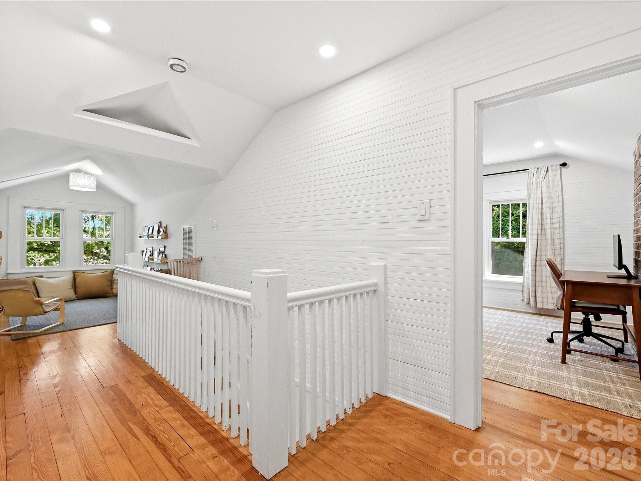 The light-filled upper landing offers beautiful hardwood floors and connects to versatile living spaces, creating an open and inviting second level. - 3514 Kelly Road, Charlotte
