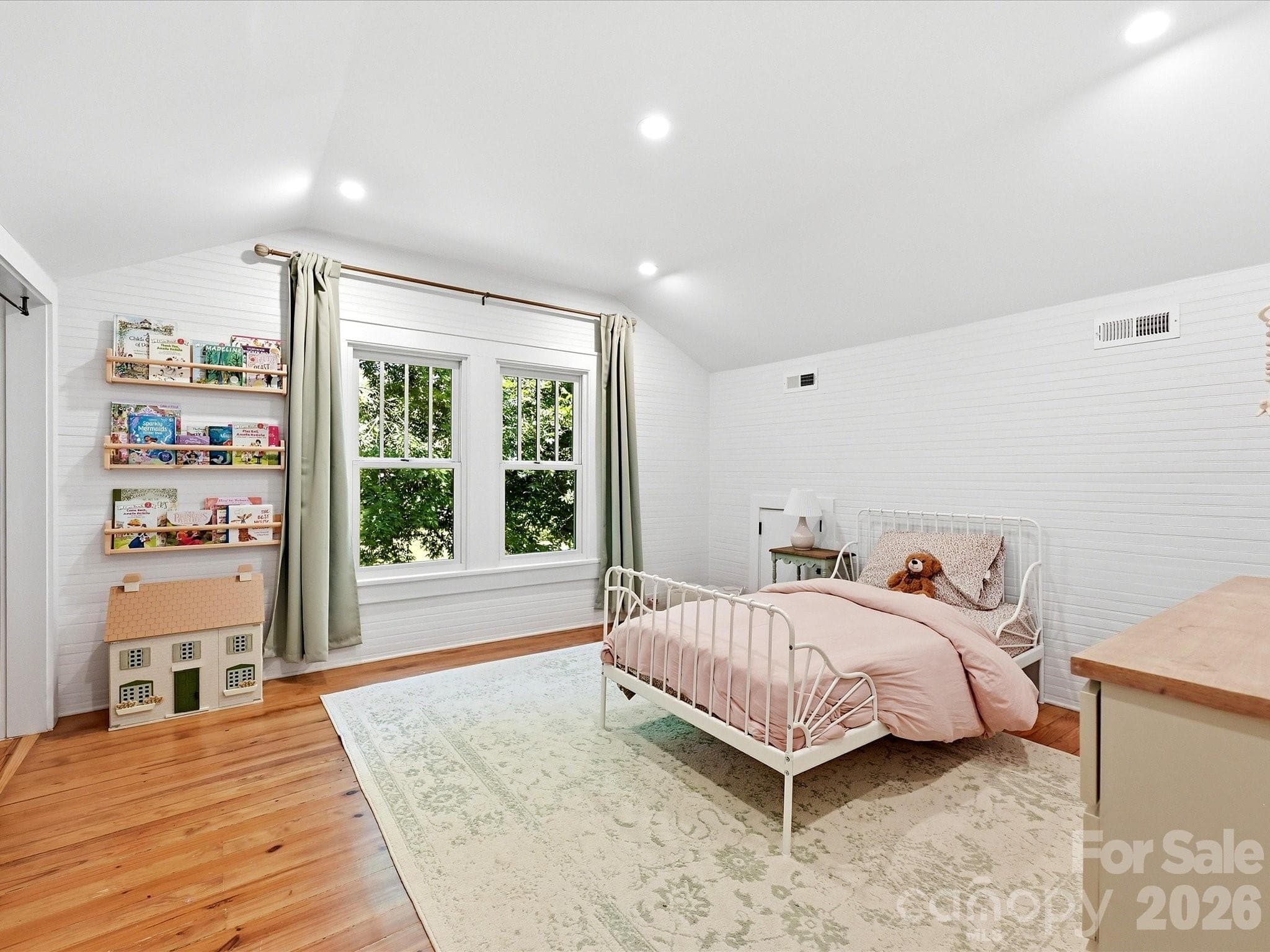 This spacious secondary bedroom features hardwood floors, abundant natural light, and plenty of room to grow, play, or create a peaceful retreat. - 3514 Kelly Road, Charlotte