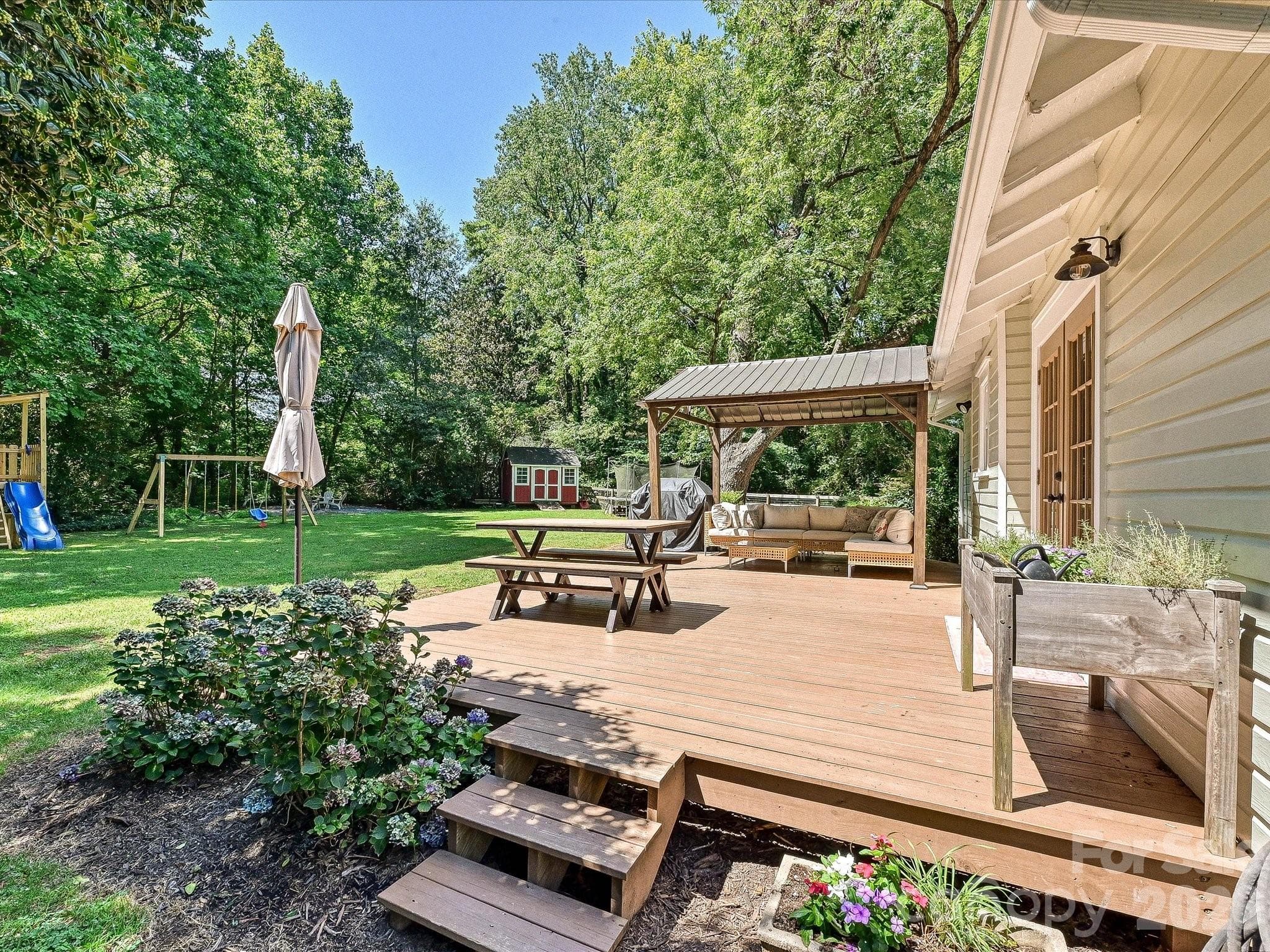 The expansive back deck offers plenty of room for outdoor dining, grilling, and entertaining beneath the covered gazebo. - 3514 Kelly Road, Charlotte