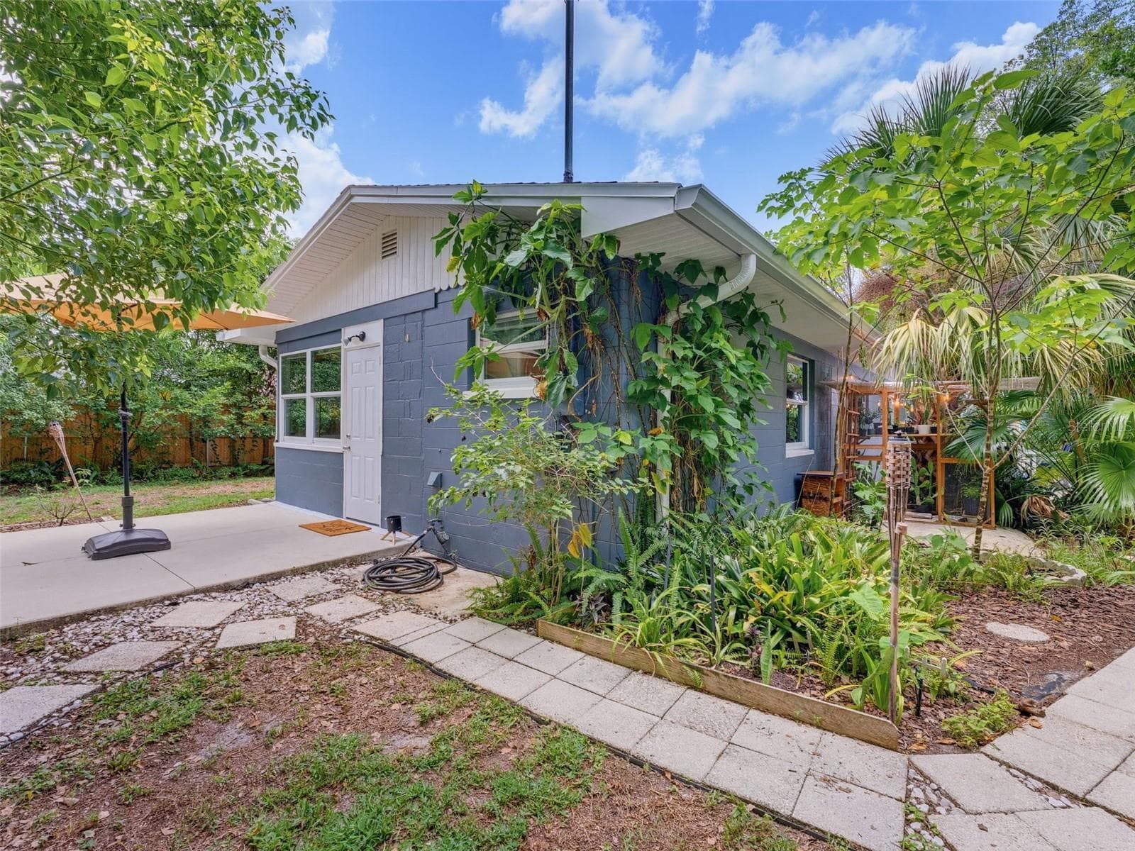 Walkways to shed and side patio connect in backyard. - 5704 13TH ST, ZEPHYRHILLS