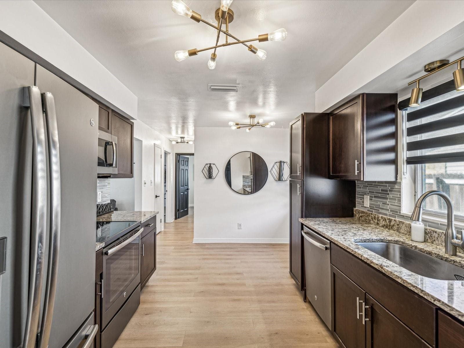 Kitchen with stainless steel appliances, granite countertops and wood cabinets - 2000 57TH ST N, ST PETERSBURG