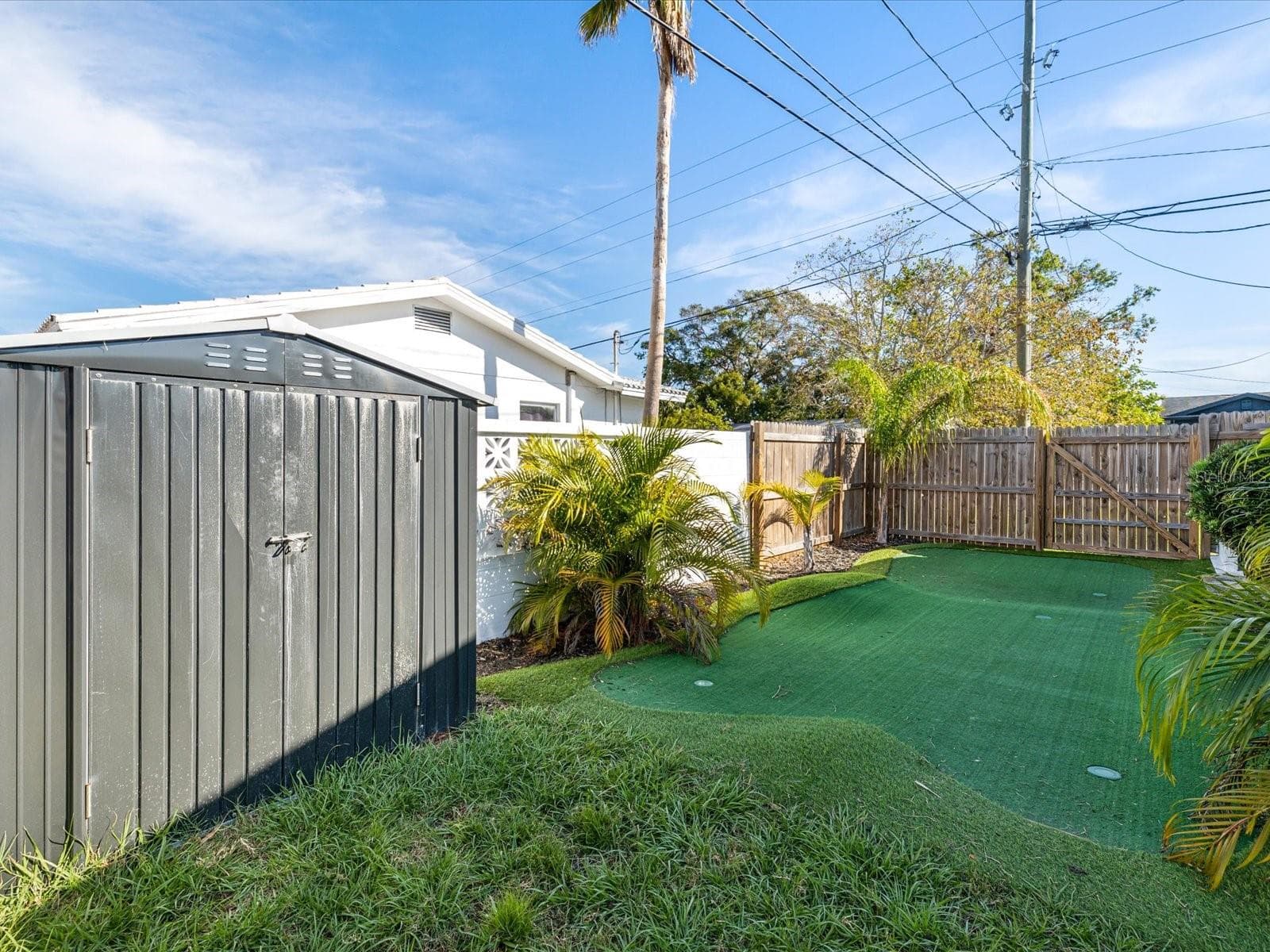 Beautifully landscaped yard with putting green and storage shed - 2000 57TH ST N, ST PETERSBURG