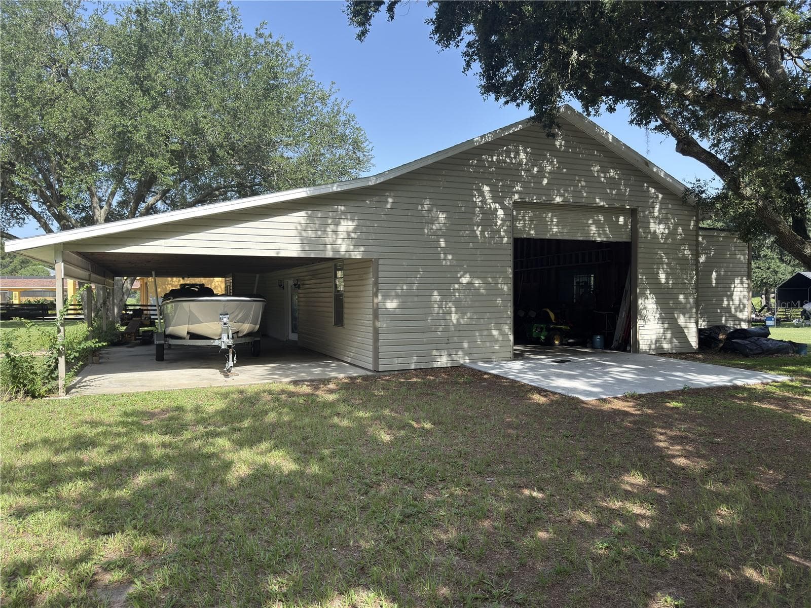 The garage has a RV-sized roll-up door on either end. - 32137 WOLF BRANCH LN, SORRENTO