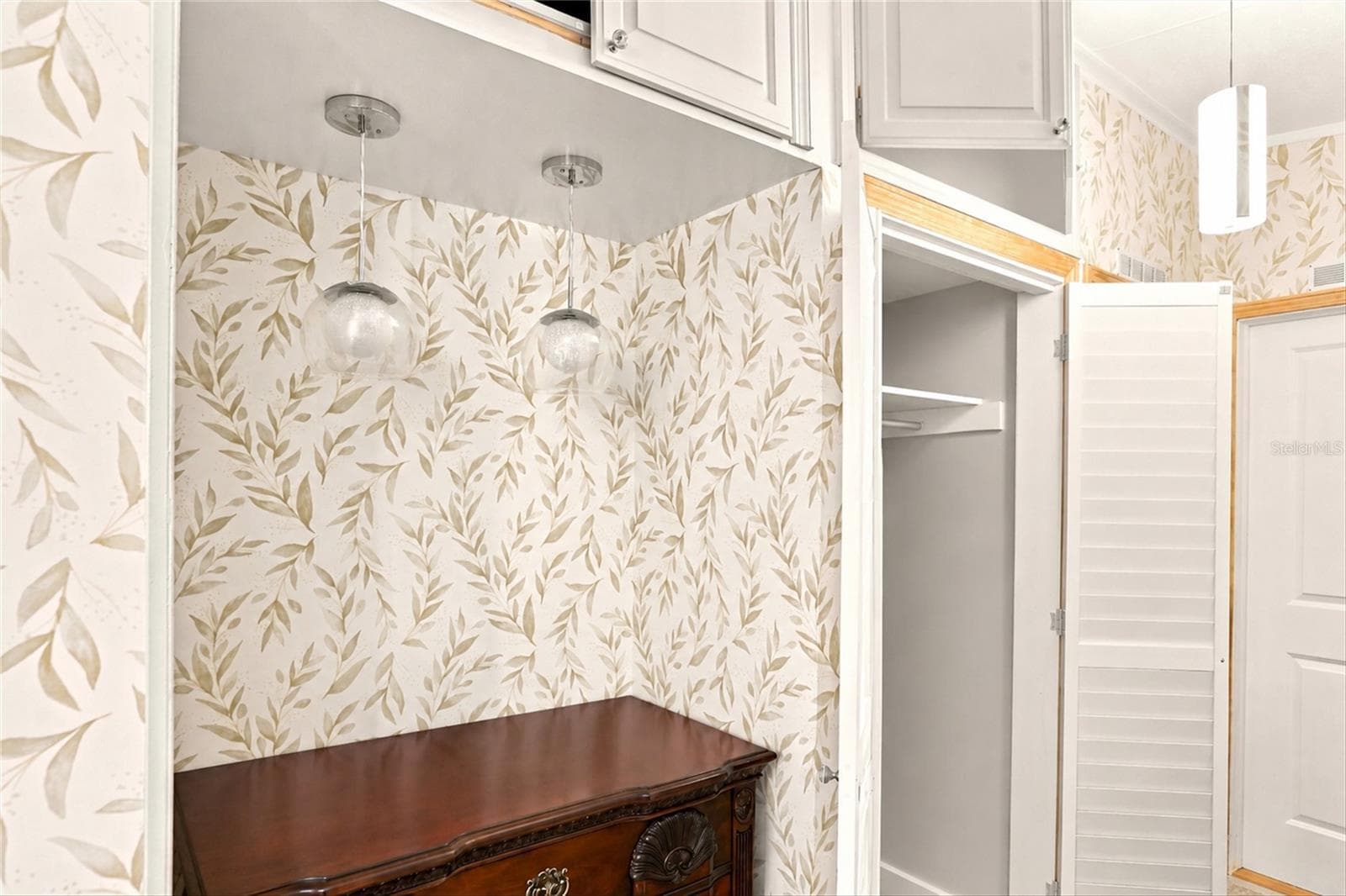 Main Hallway with Coat Closet and Storage Above - 1 POINSETTIA DR, FORT MYERS