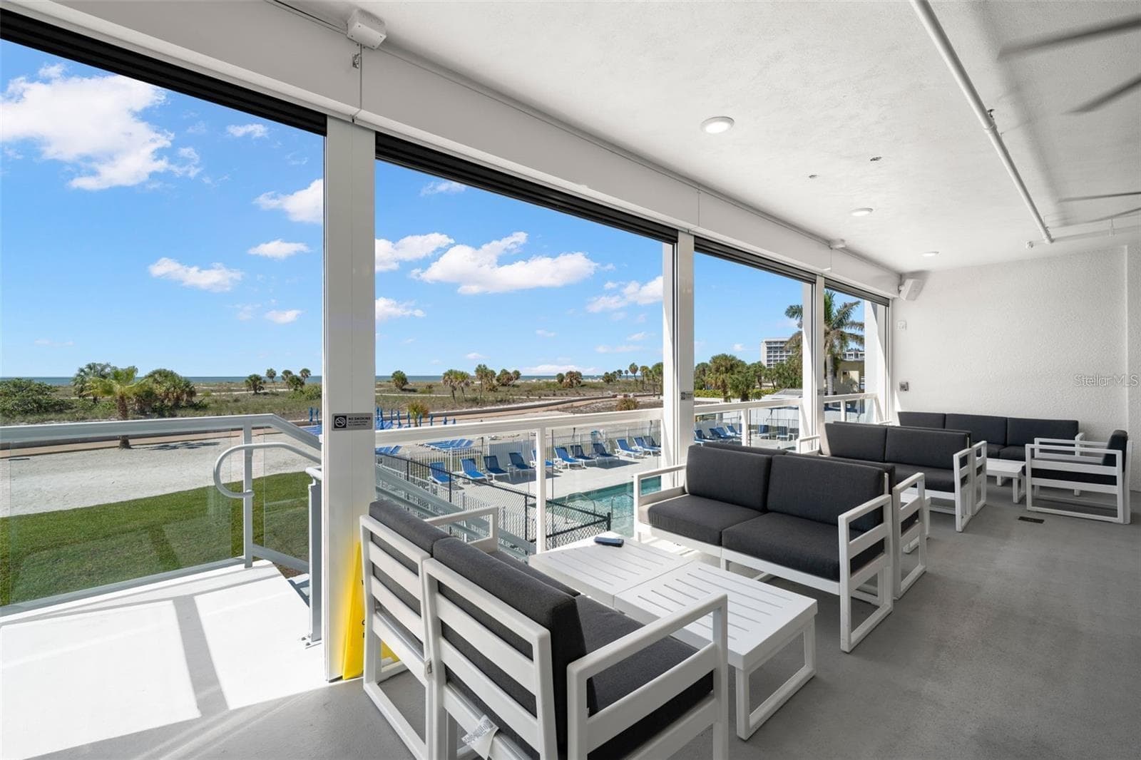 BAR LOUNGE AREA WITH STAIRS DOWN TO THE POOL DECK - 11500 GULF BLVD #304, TREASURE ISLAND