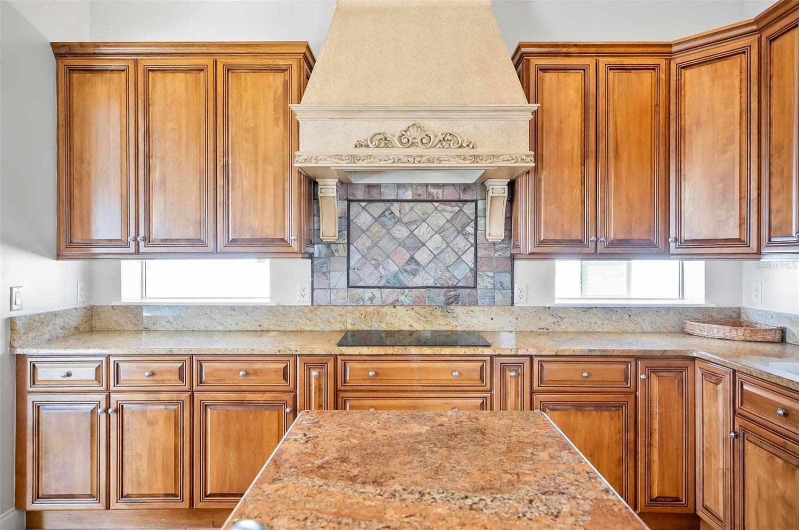 Beautiful luxury custom cabinetry and range hood in kitchen - 88 HIDDEN CV, FLAGLER BEACH