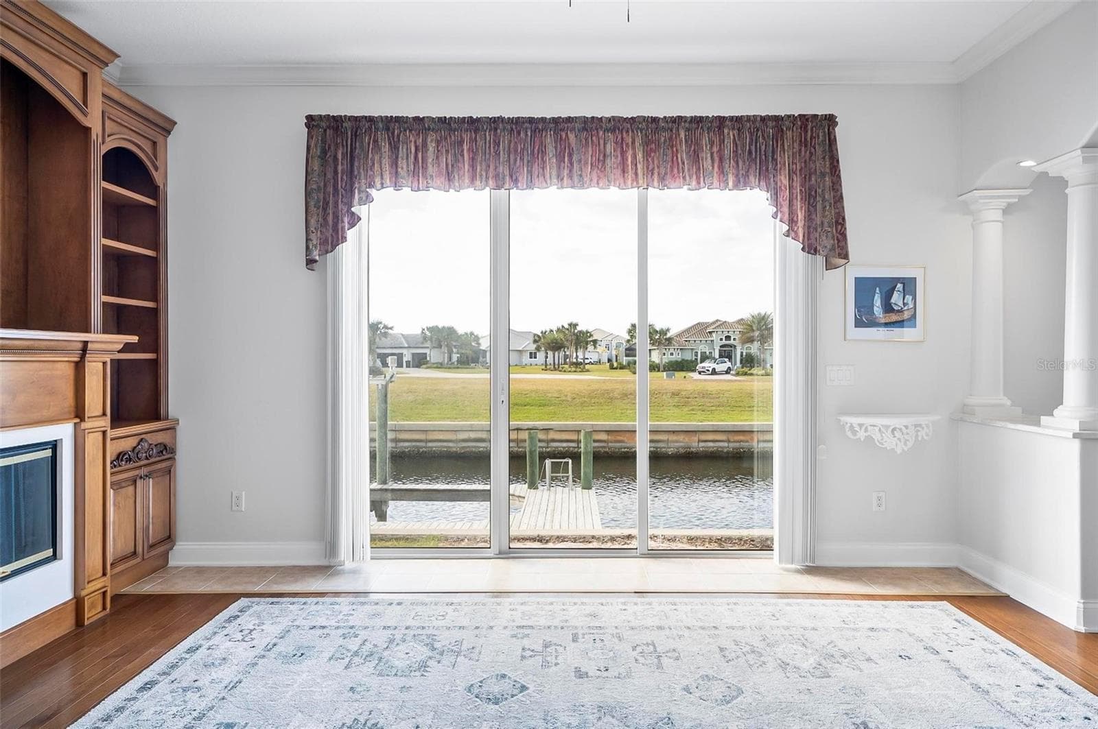Formal living room with built in custom shelving overlooking canal front looking west - 88 HIDDEN CV, FLAGLER BEACH
