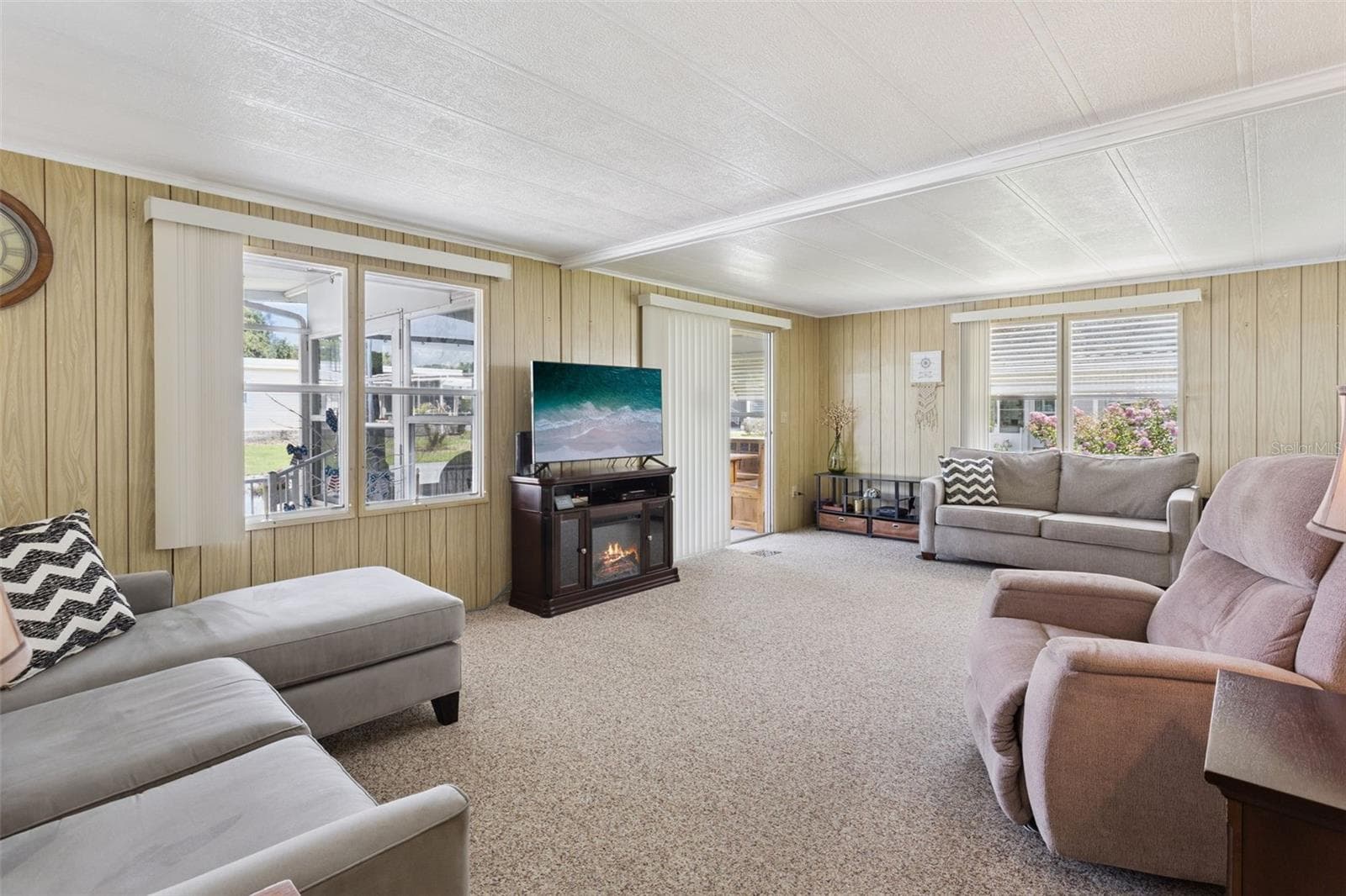 THE LIVING ROOM HAS A COZY FREE-STANDING FIREPLACE TO STAY COZY ON A CHILLY WINTER NIGHT. - 104 OLEANDER CV, LEESBURG