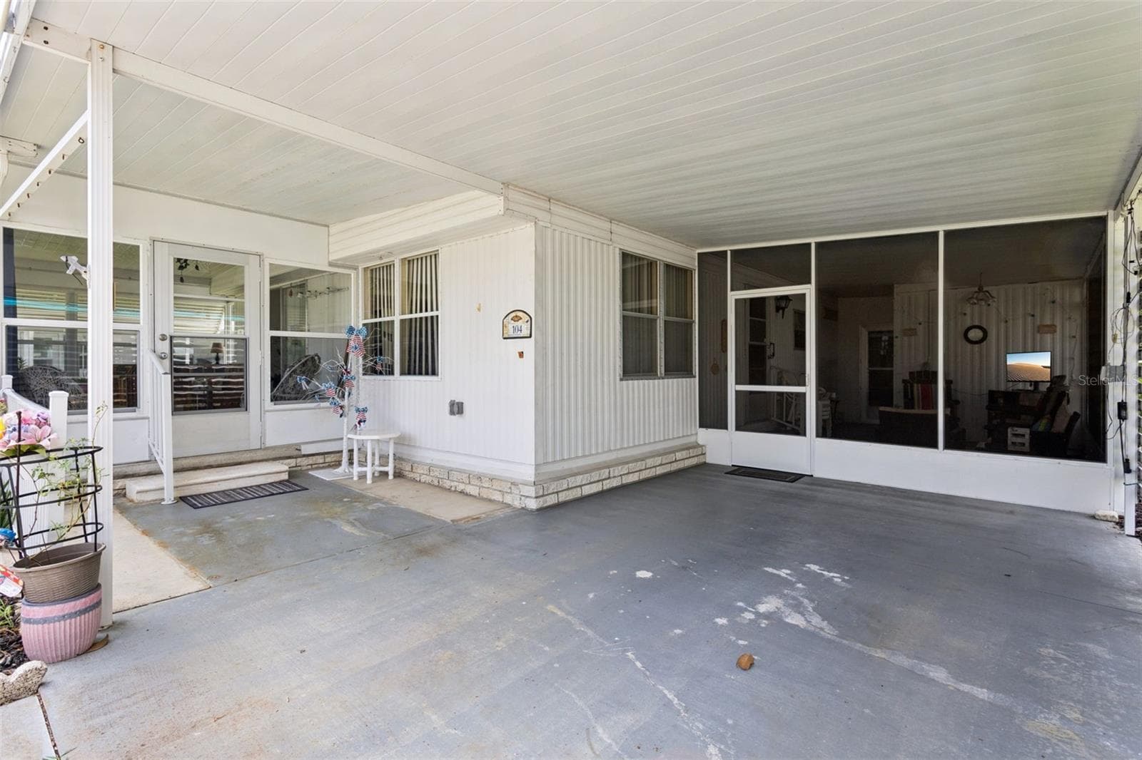 THE SPACIOUS CARPORT HAS ROOM ENOUGH FOR AN AUTO PLUS A GOLF CART. - 104 OLEANDER CV, LEESBURG